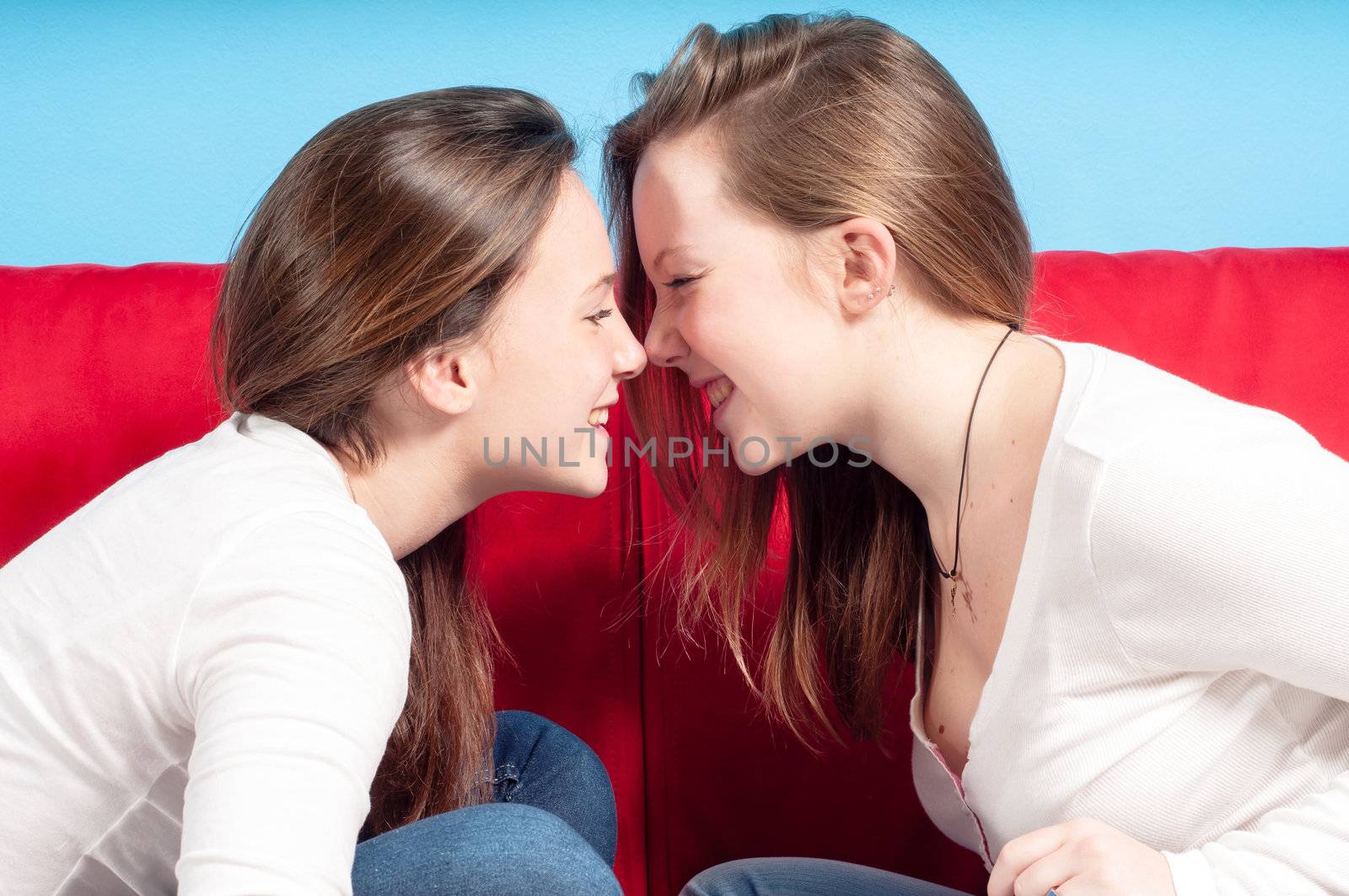 sisters playing nose to nose on the couch in the living room