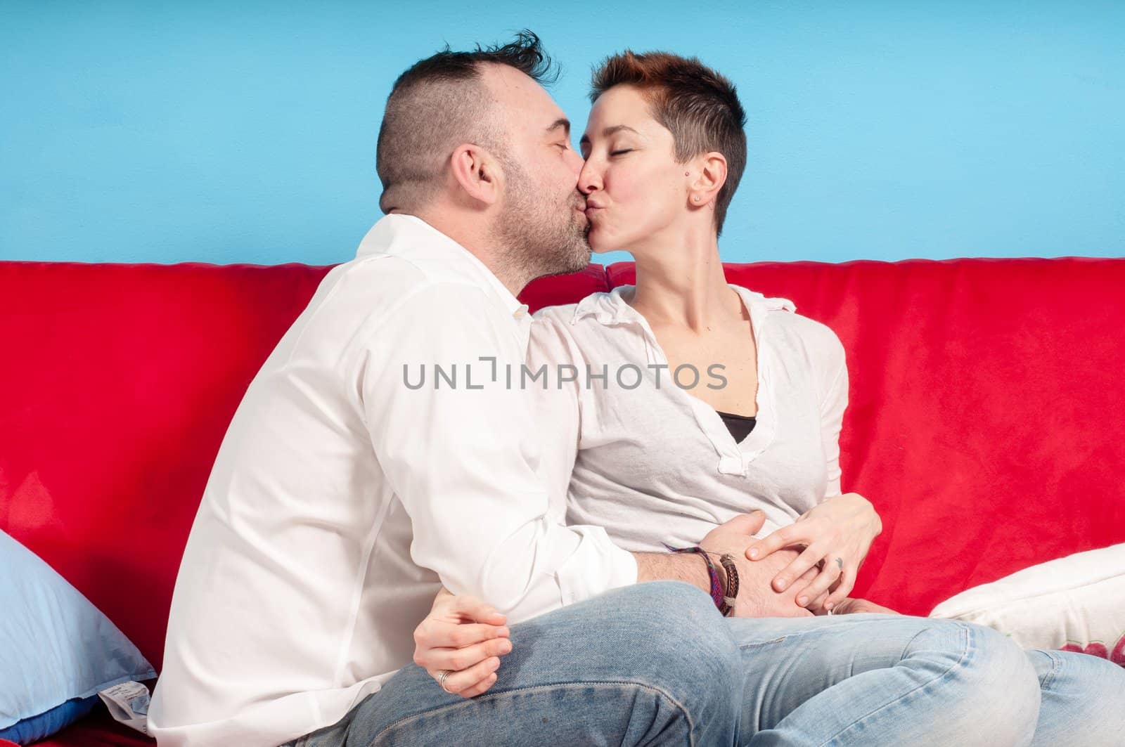 husband and wife hugging on the couch in the living room