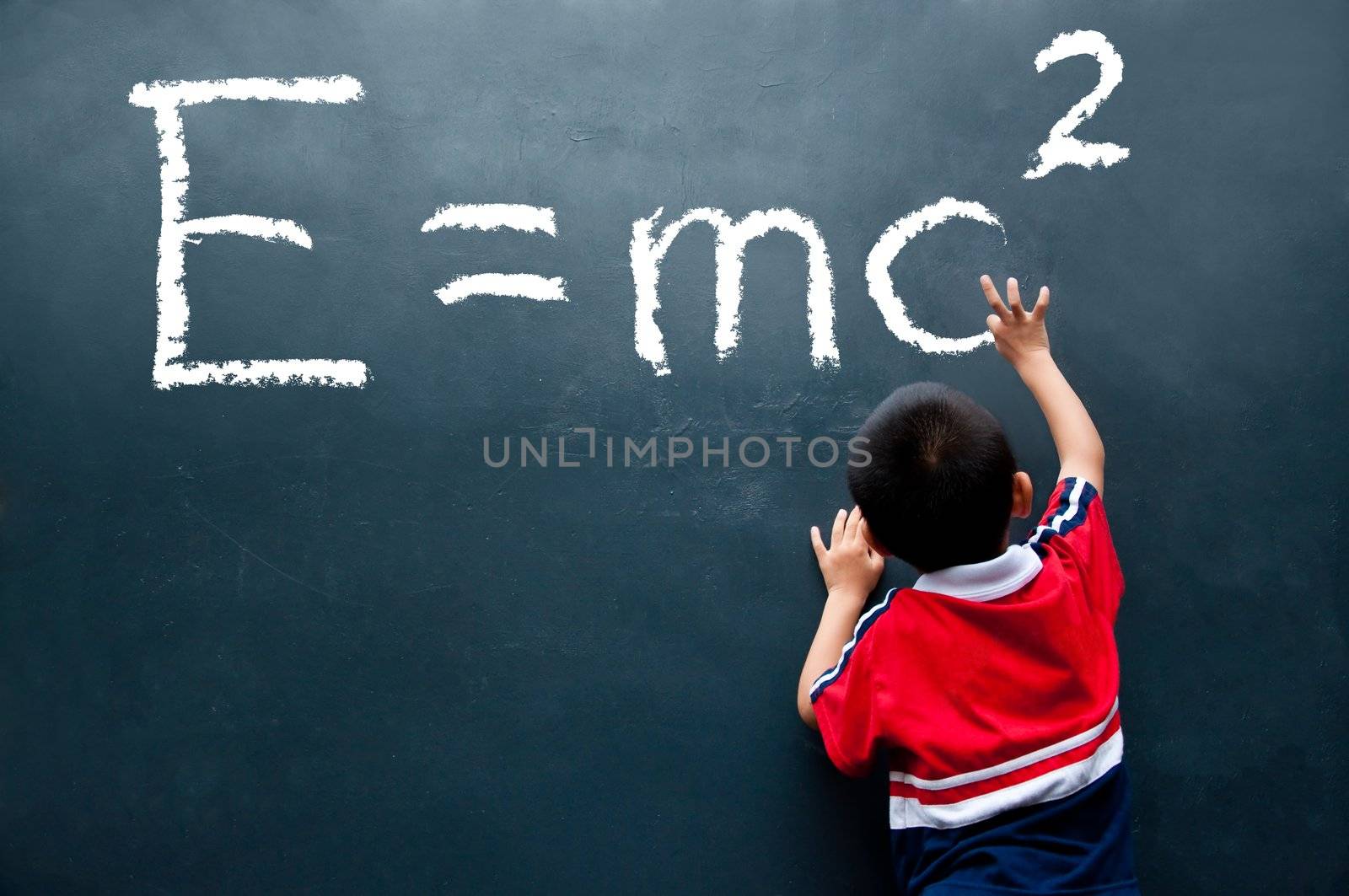 The boy is writing the formula for e=mc2