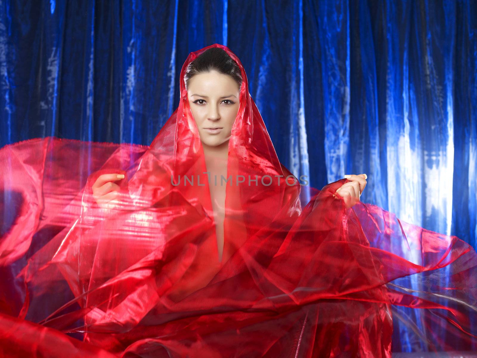Amazing 40 mega pixels: Mystic and beautiful lady in red silk on blue background