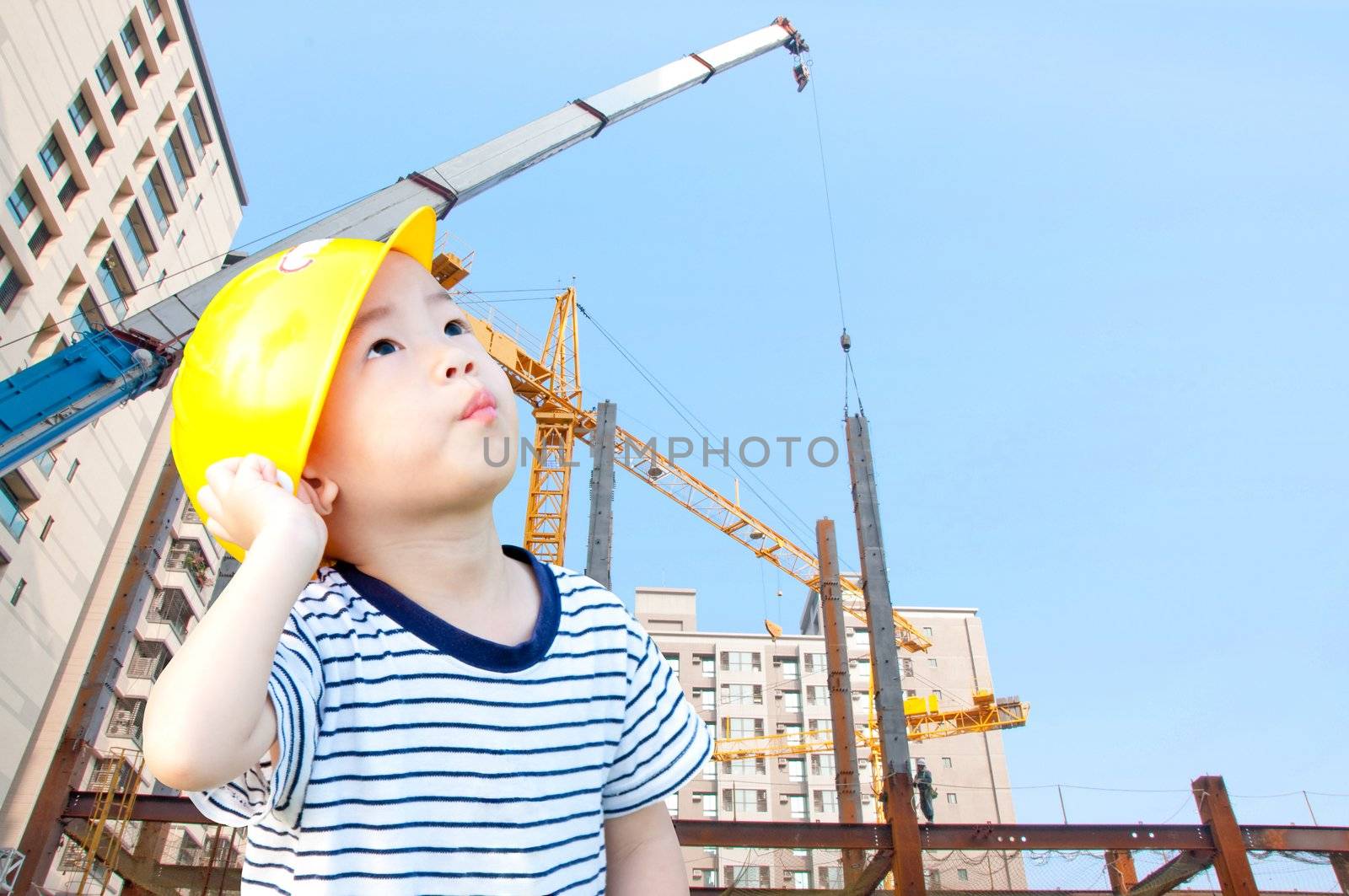 Cute boy engineer, wearing a yellow hat