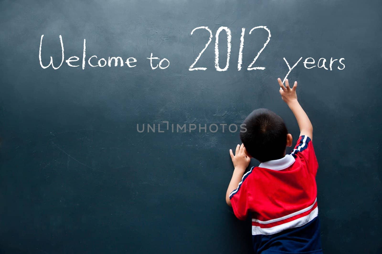 Boy writing on the wall and welcome to 2012 years
