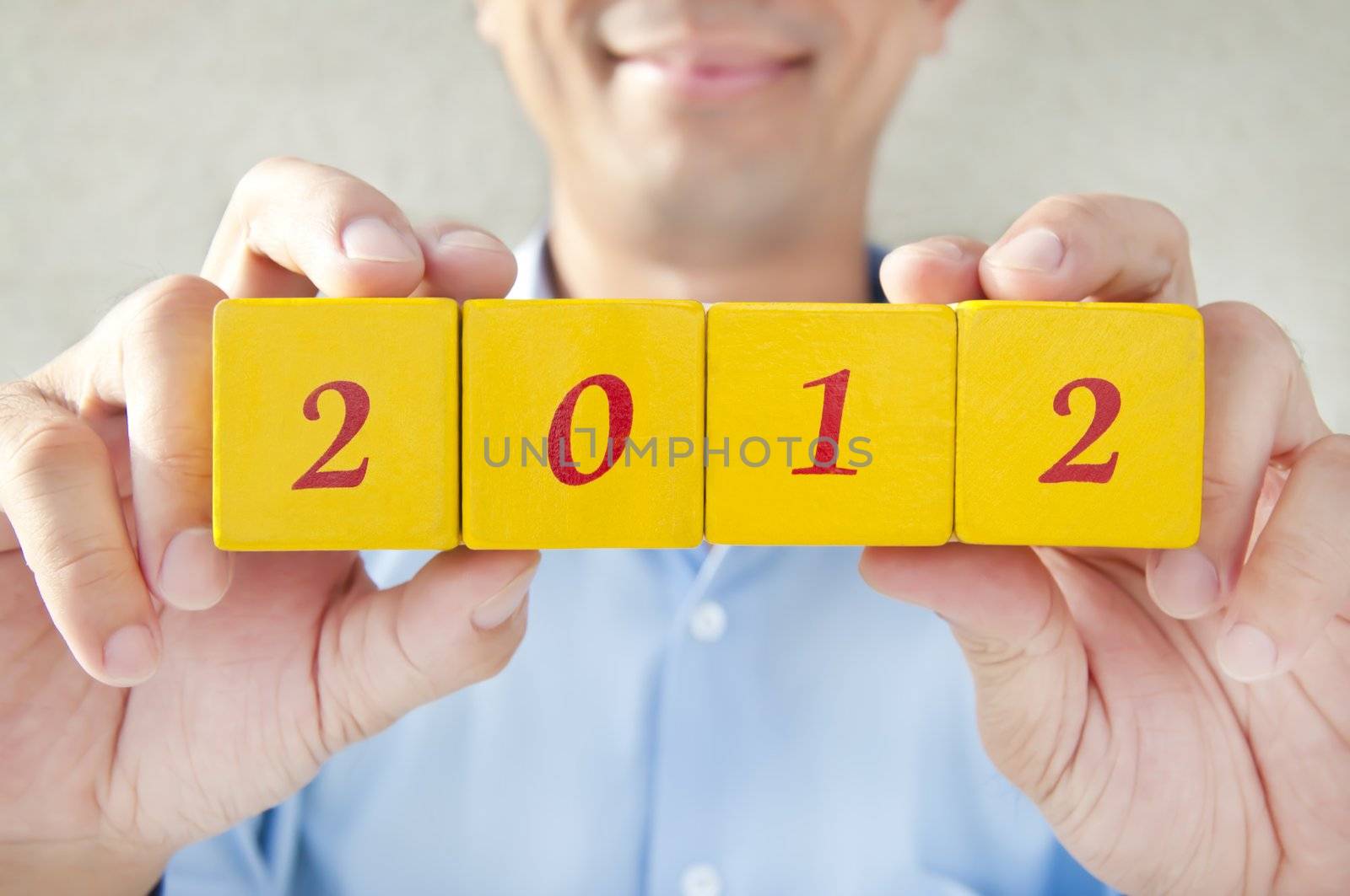 Salesman holding building blocks, building blocks that read 2012, Representatives for the 2012 years