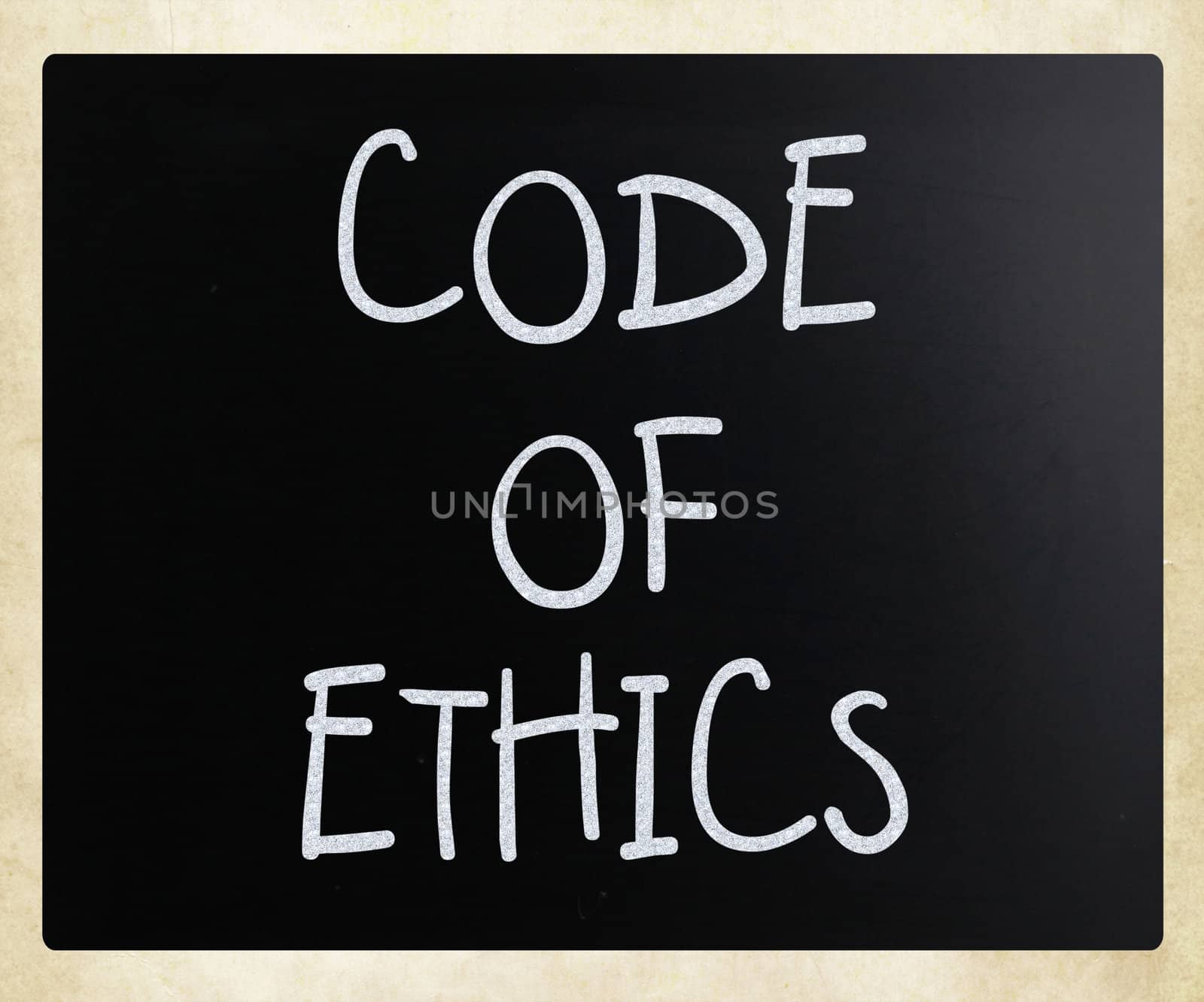 "Code of ethics" handwritten with white chalk on a blackboard