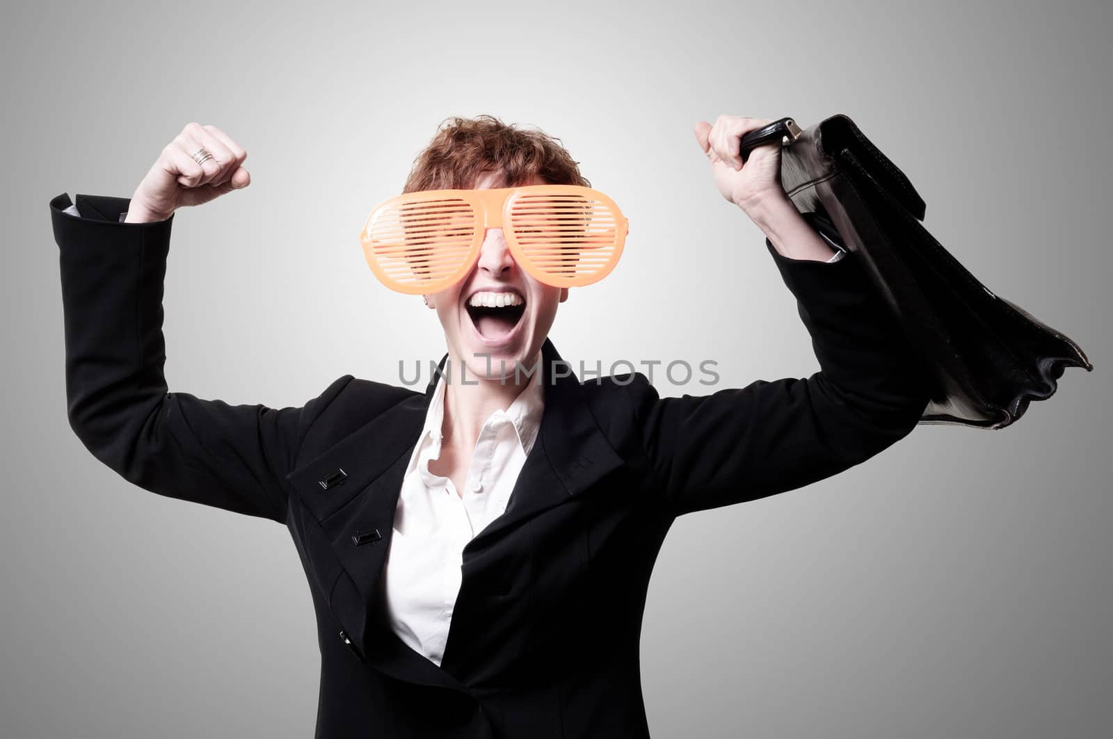 businesswoman with big funny eyeglasses and briefcase on gray background