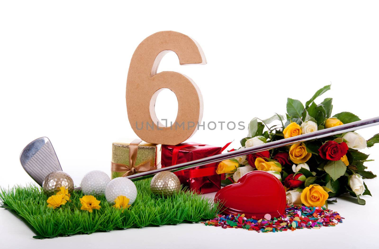 Roses, a golf club and golf balls on an artificial peace of grass to be used as a birthday card