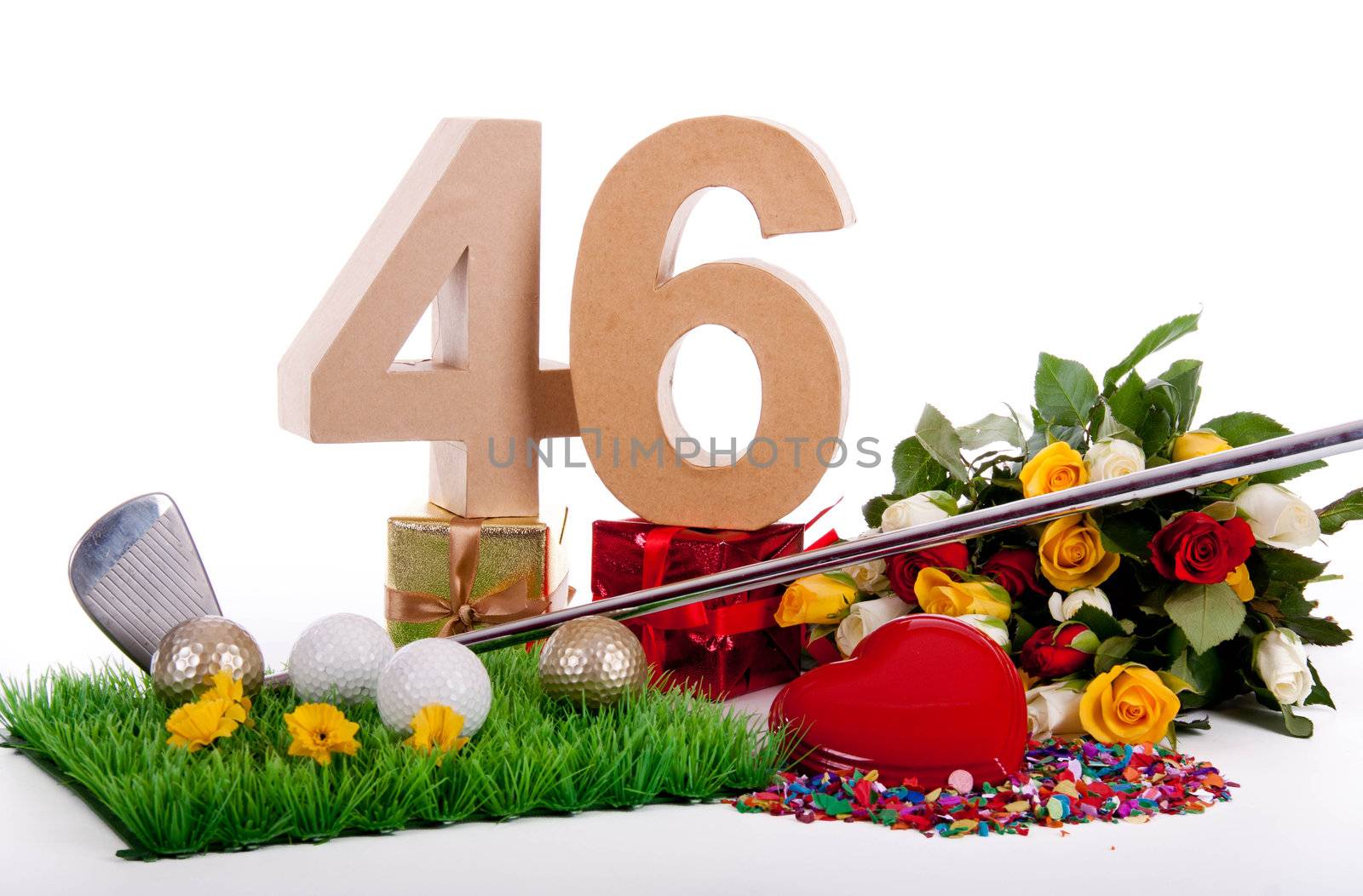 Roses, a golf club and golf balls on an artificial peace of grass to be used as a birthday card