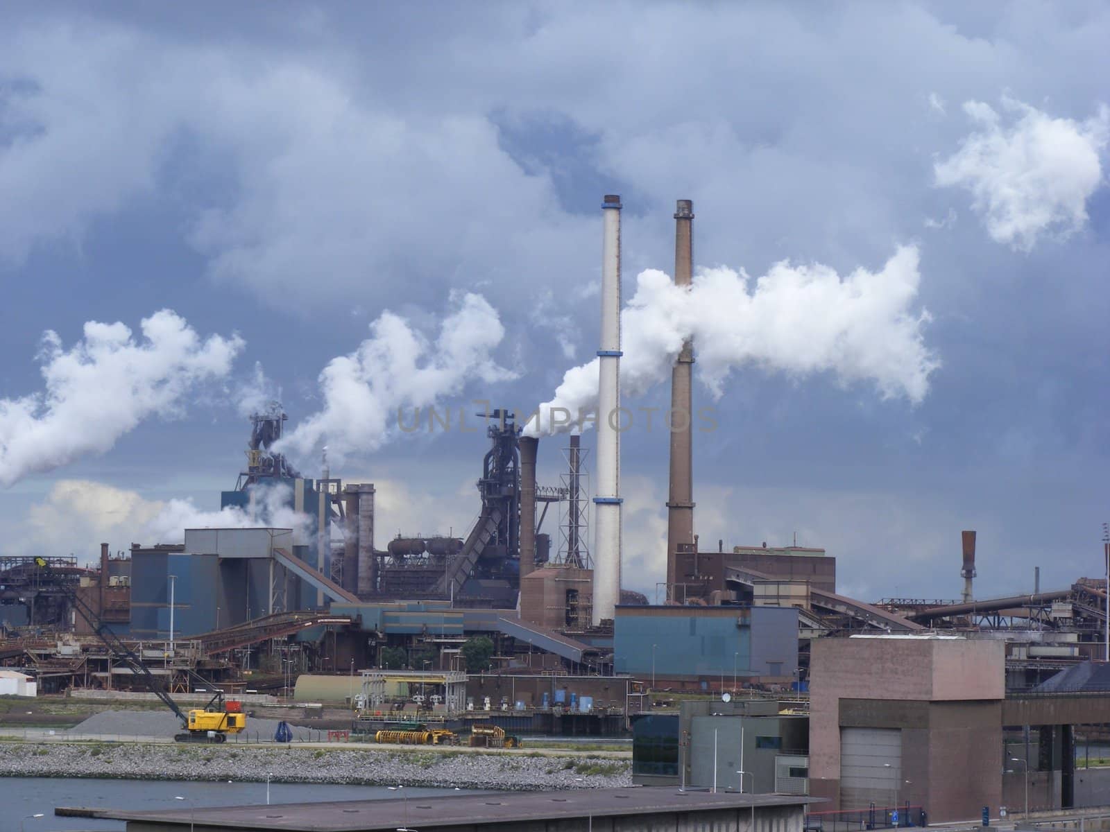 Photo of industrial buildings and smoke towers