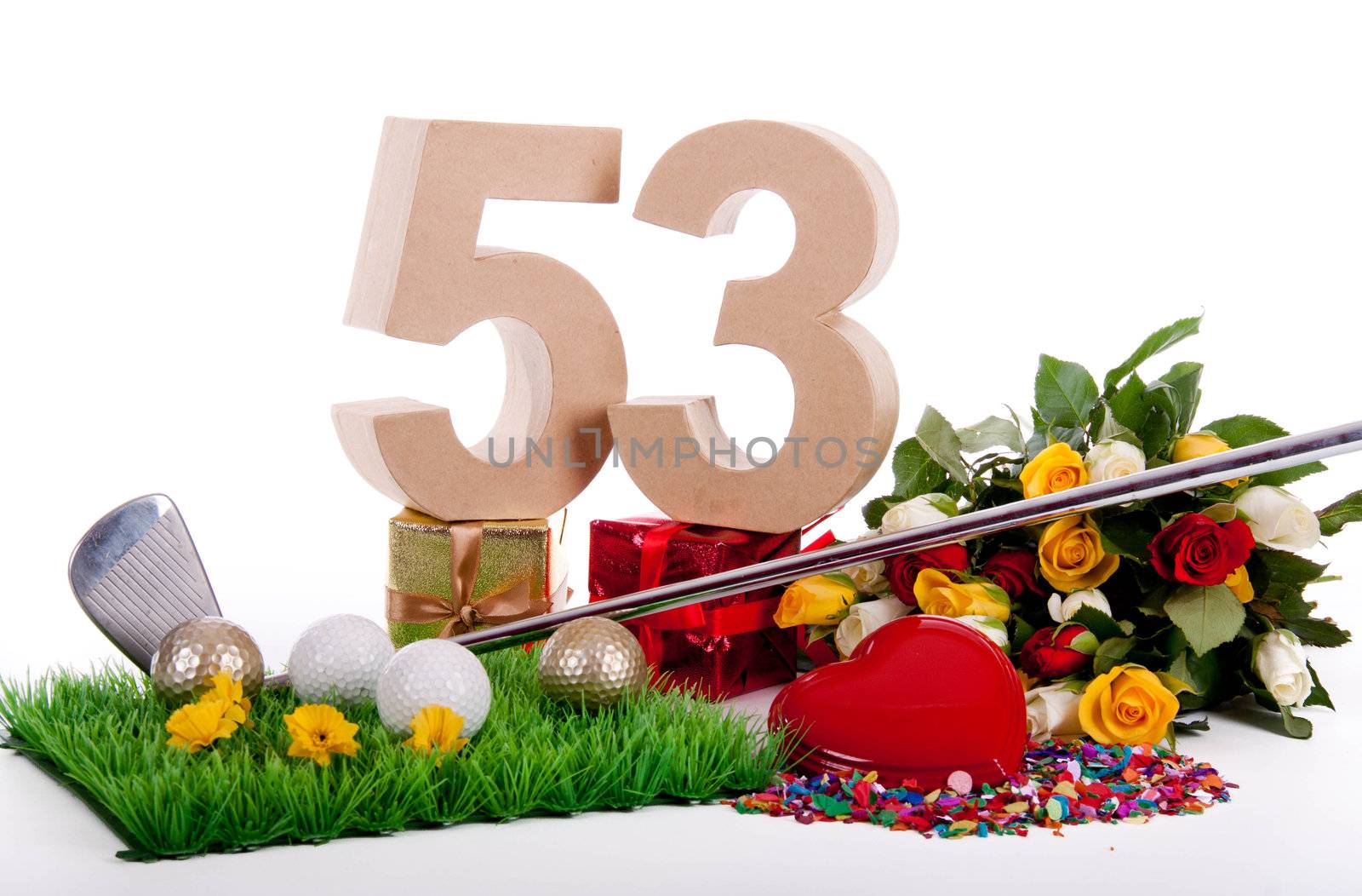 Roses, a golf club and golf balls on an artificial peace of grass to be used as a birthday card