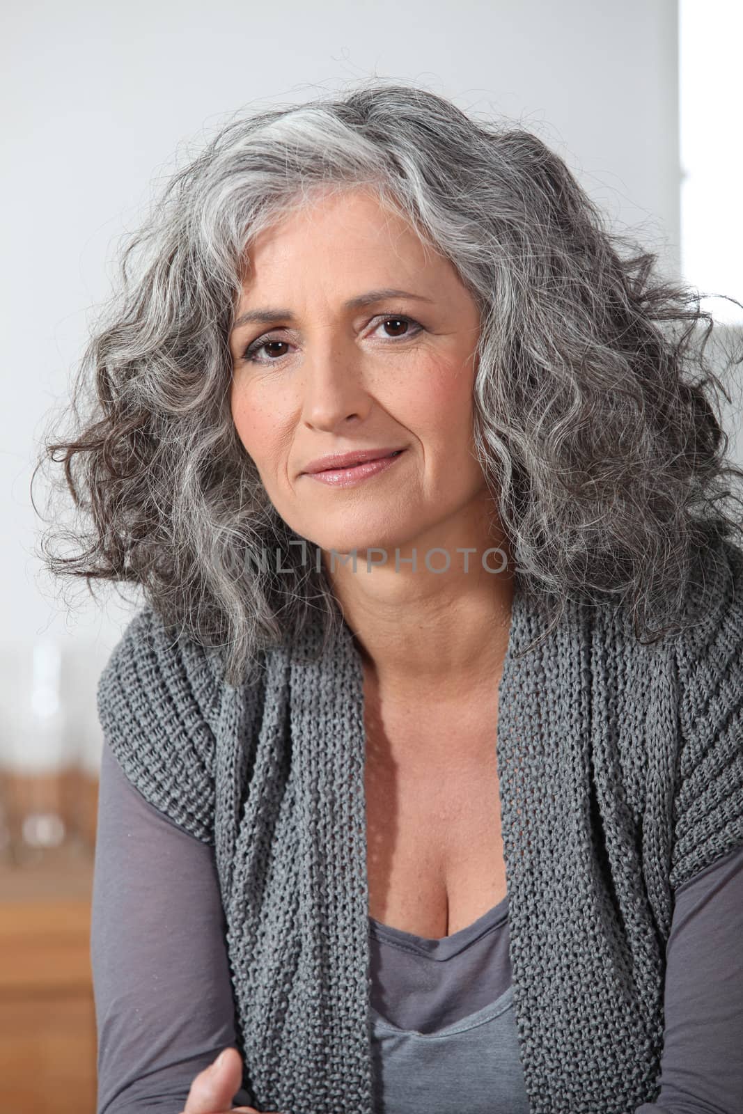 Grey-haired lady sat at home alone