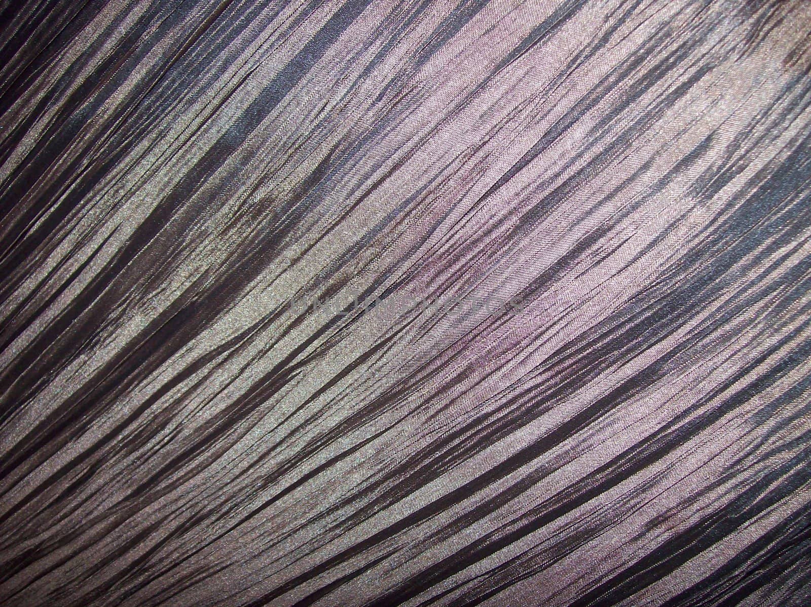 Close-up photo of creased shiny fabric