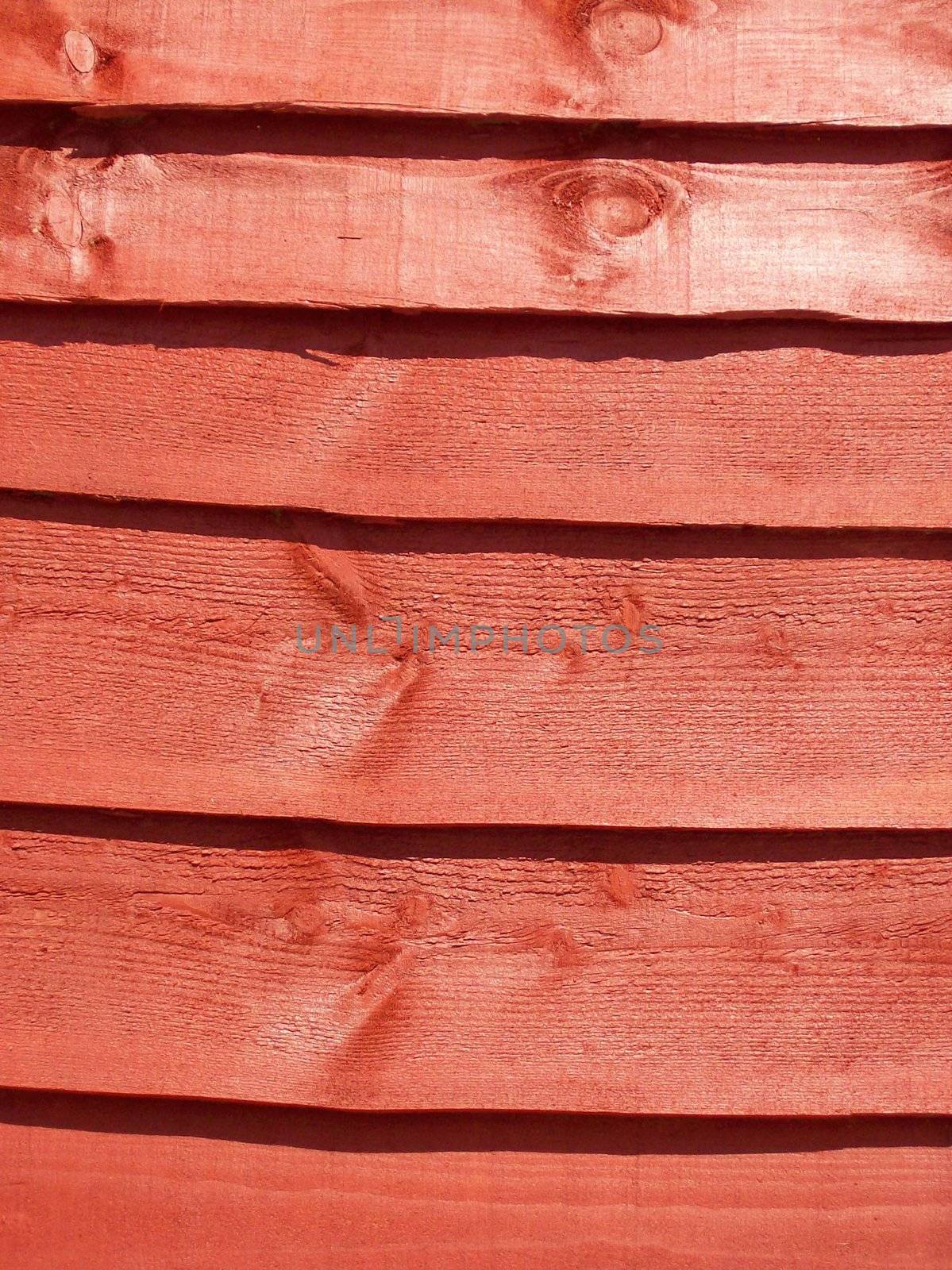 Close-up photo of a stained fence panel