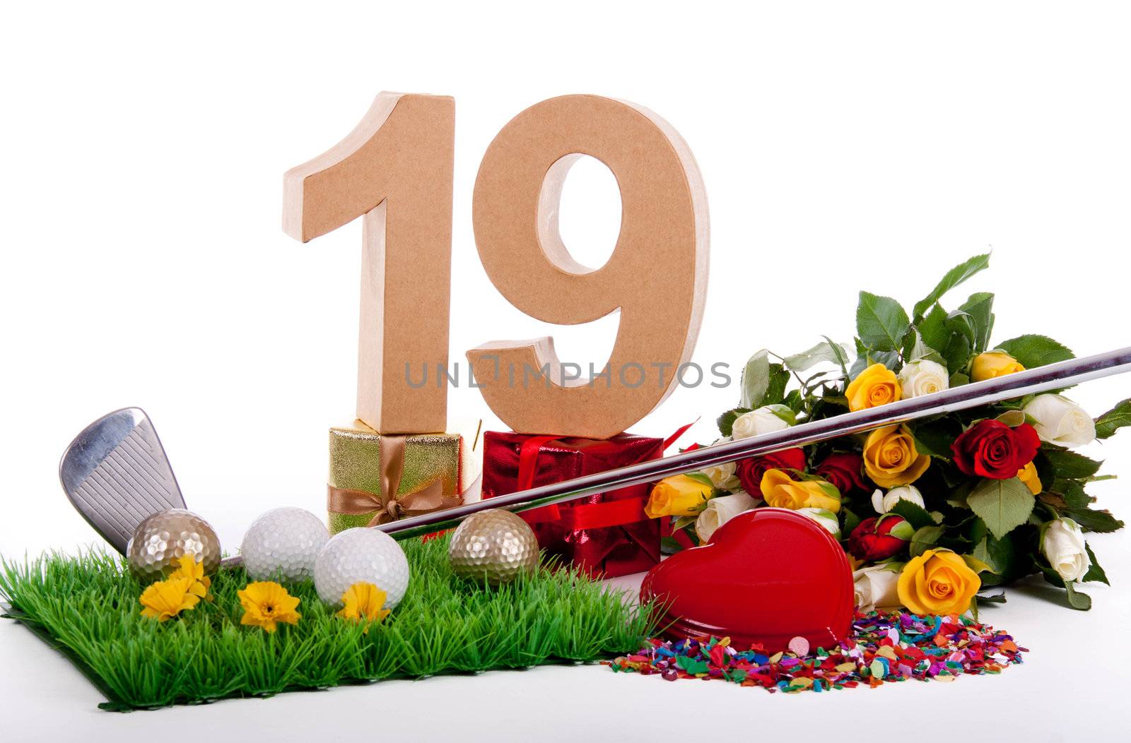 Roses, a golf club and golf balls on an artificial peace of grass to be used as a birthday card