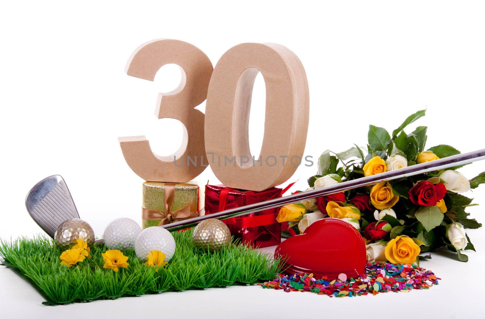 Roses, a golf club and golf balls on an artificial peace of grass to be used as a birthday card