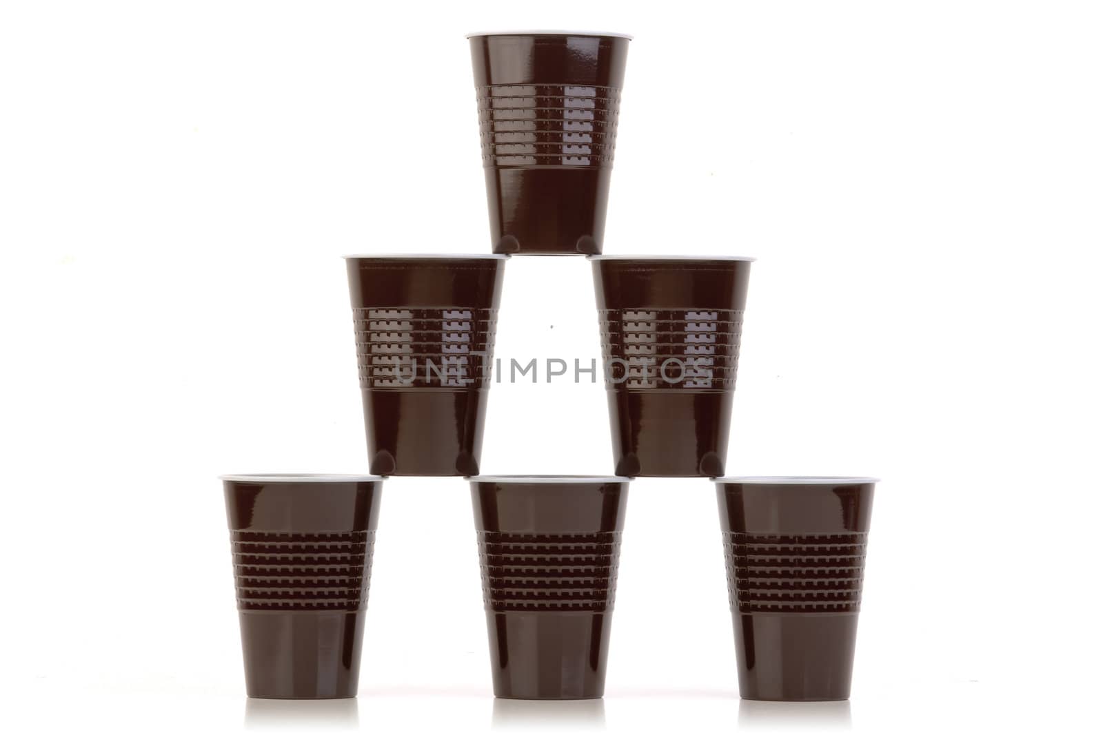 Stack of brown plastic cups arranged on white.