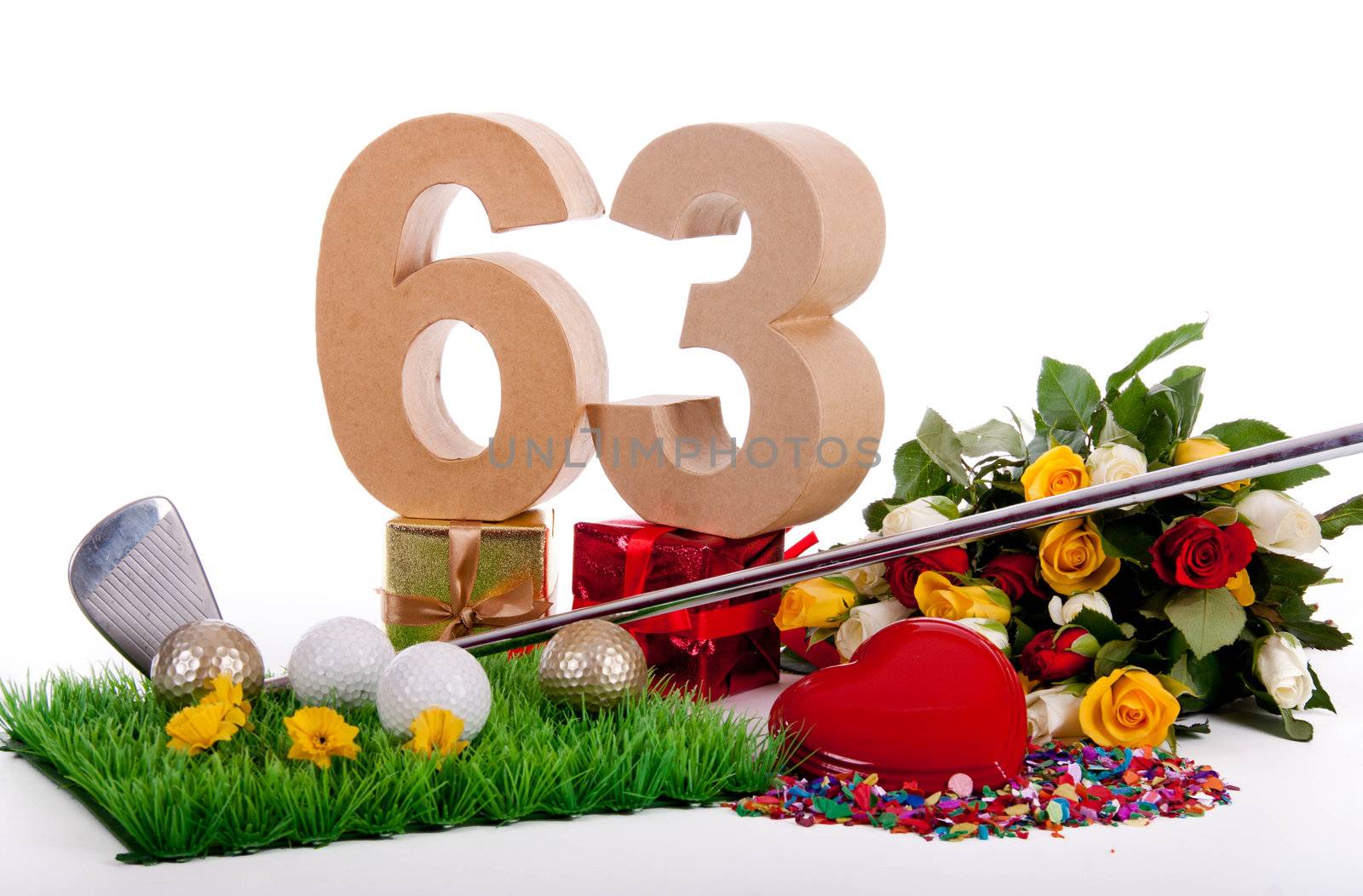 Roses, a golf club and golf balls on an artificial peace of grass to be used as a birthday card