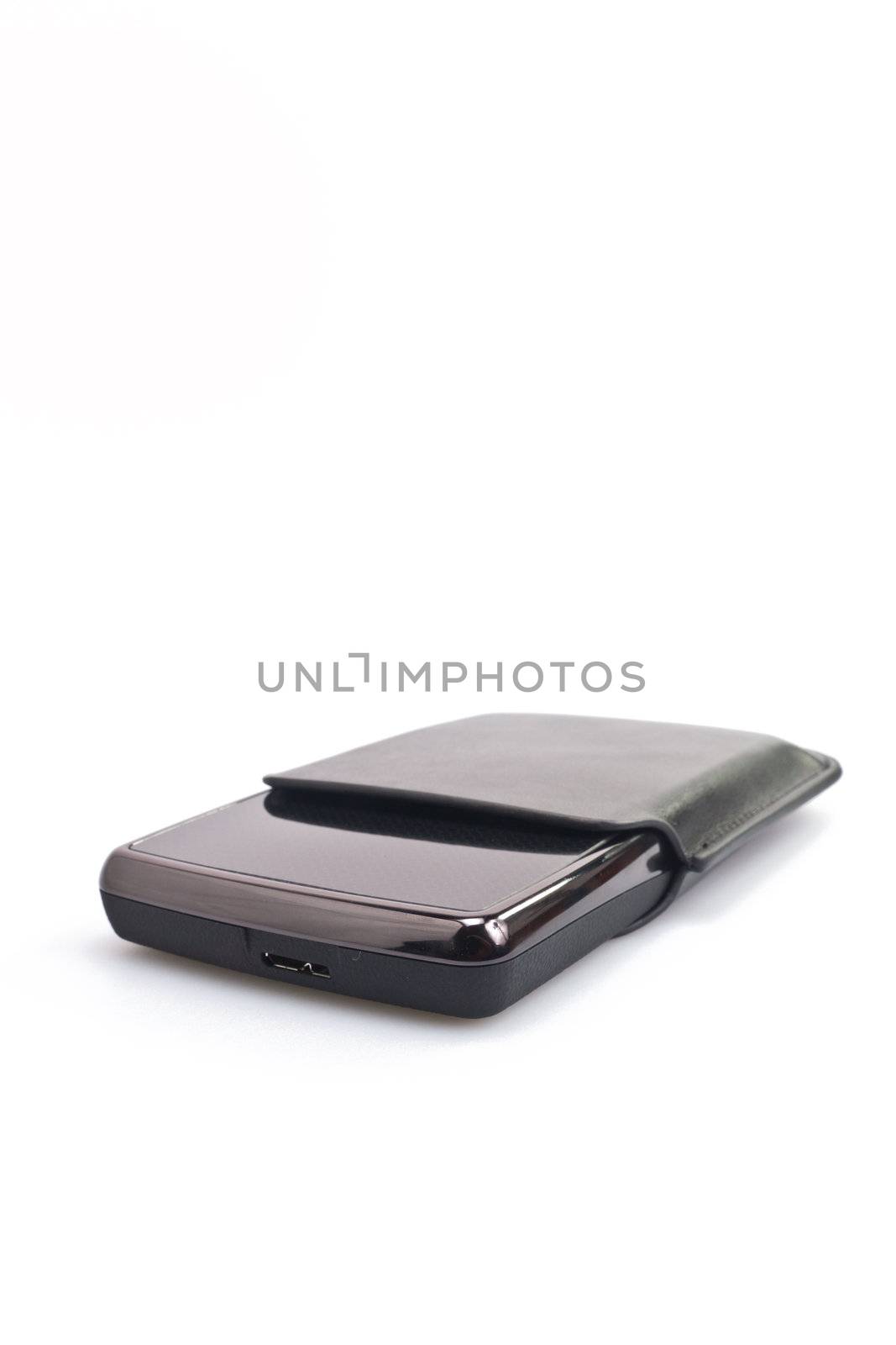 angled view of a portable harddisk with soft leather case on white background in portrait orientation