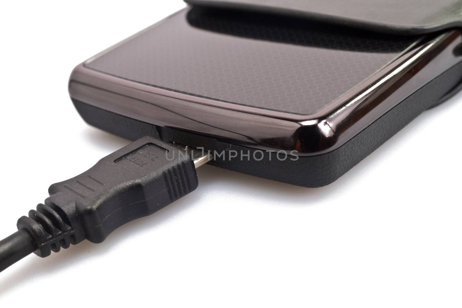 close up view of a portable harddisk in  soft leather case and USB cable on white background