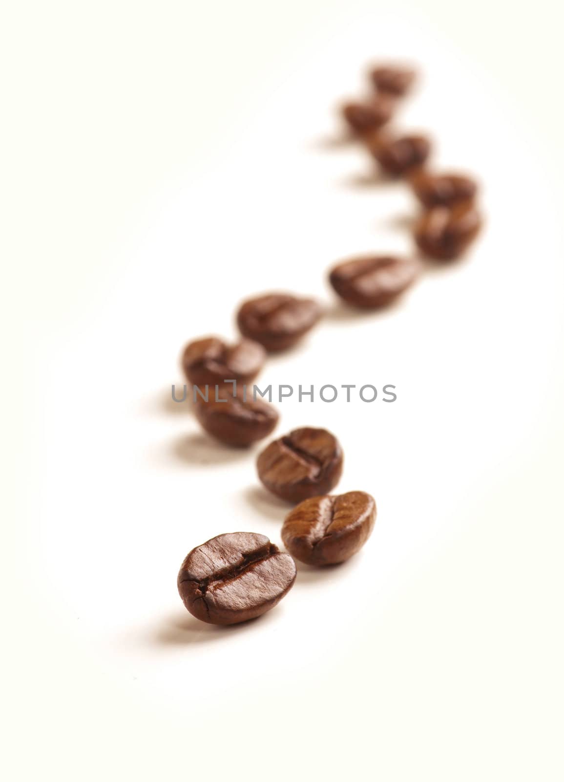 Coffee Beans draw a zigzag line isolated on white. Soft focus.