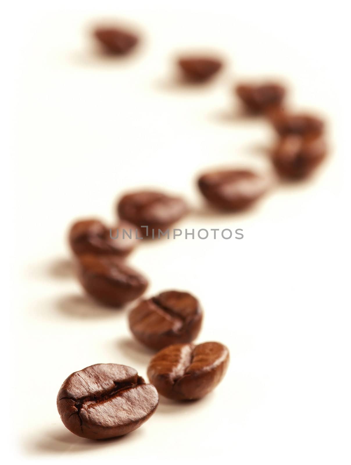 Coffee Beans draw a zigzag line isolated on white. Soft focus.