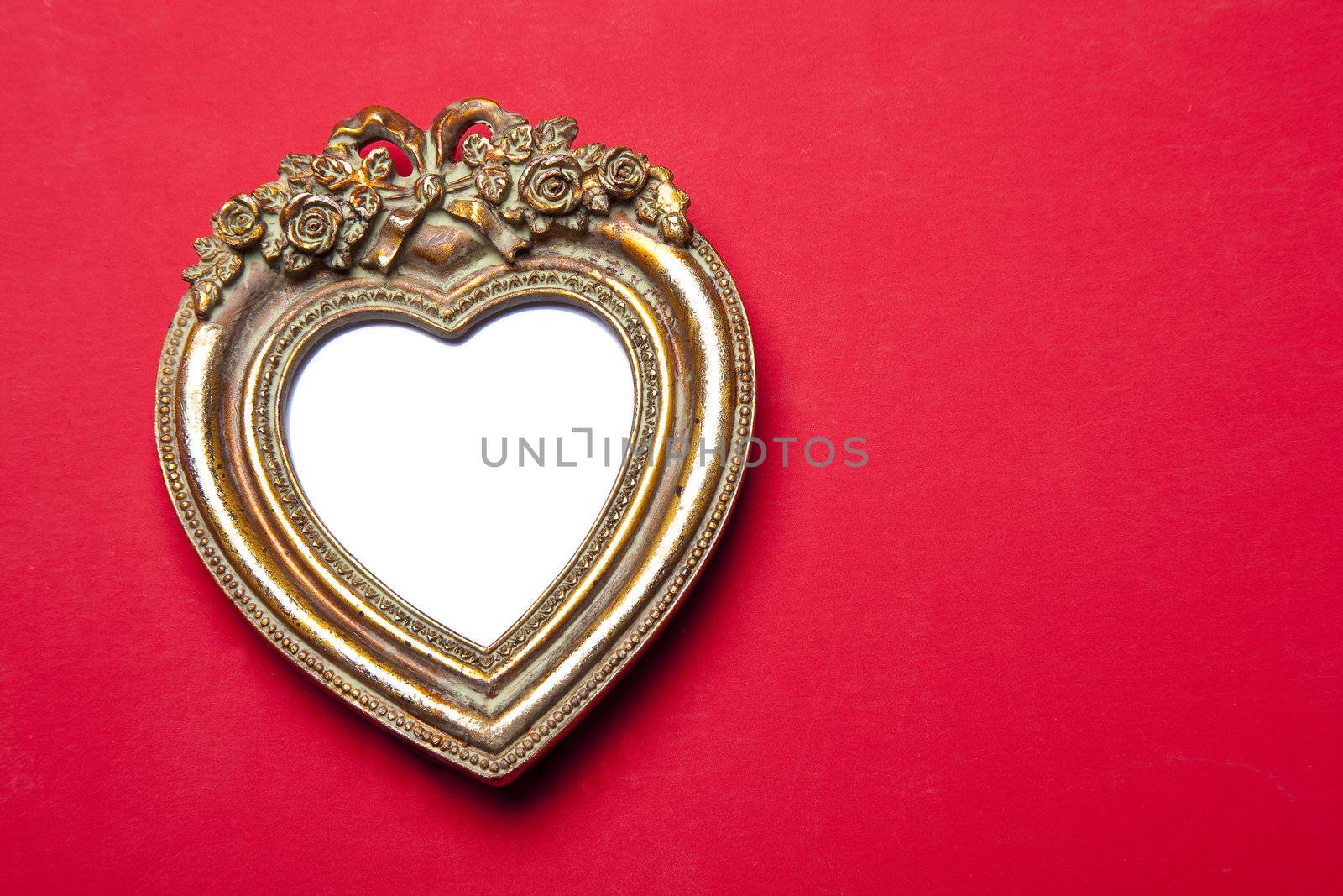 Retro Old Classic Gold Heart Picture Frame on red background