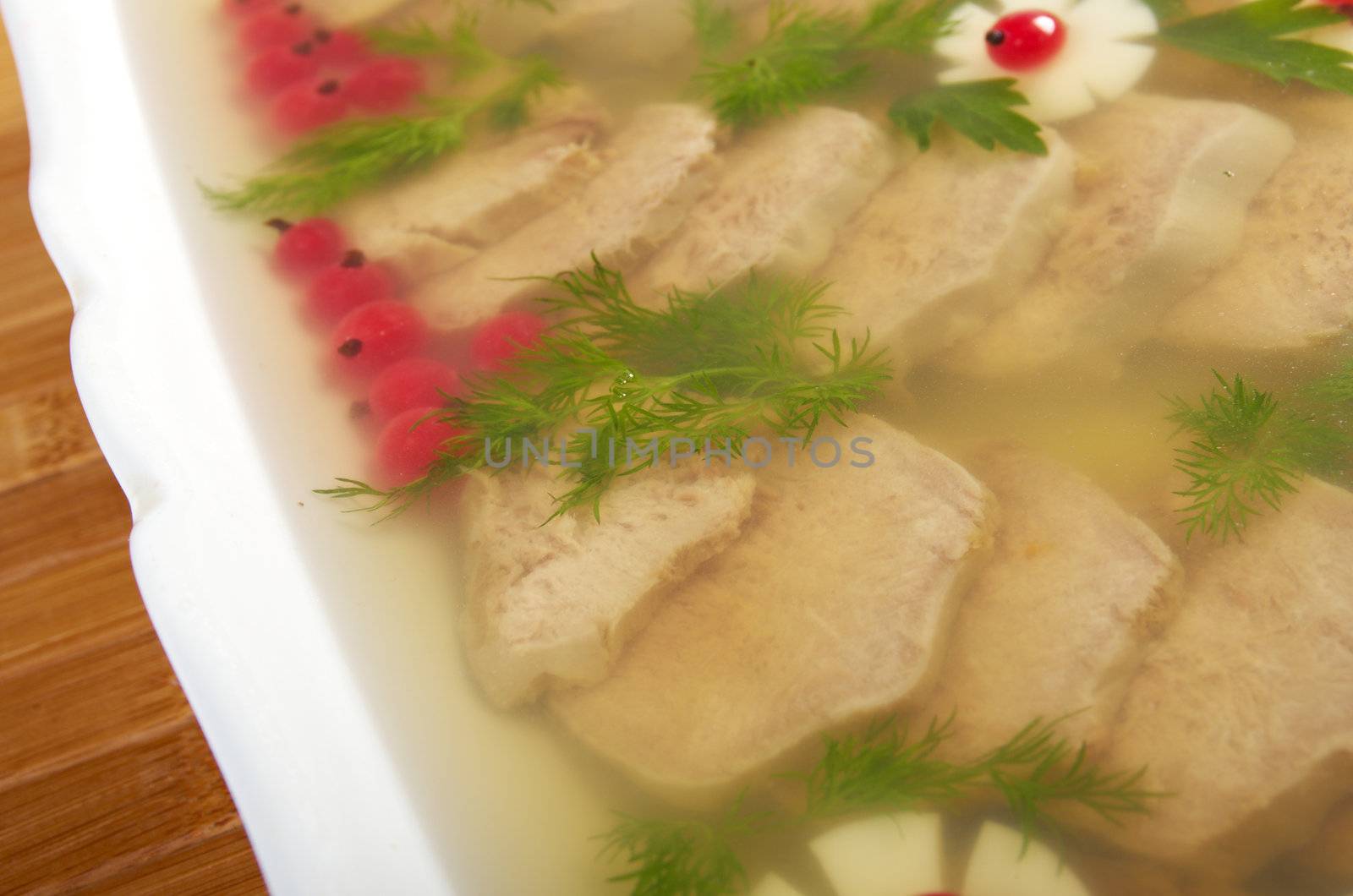 Aspic from meat decorated with egg, carrot,