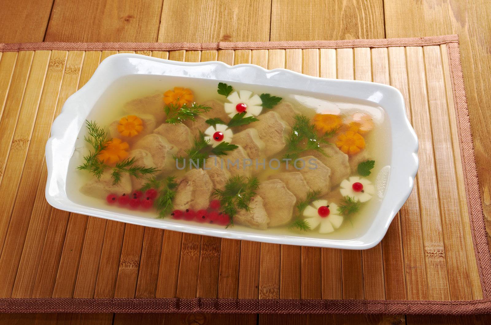 Aspic from meat decorated with egg, carrot,