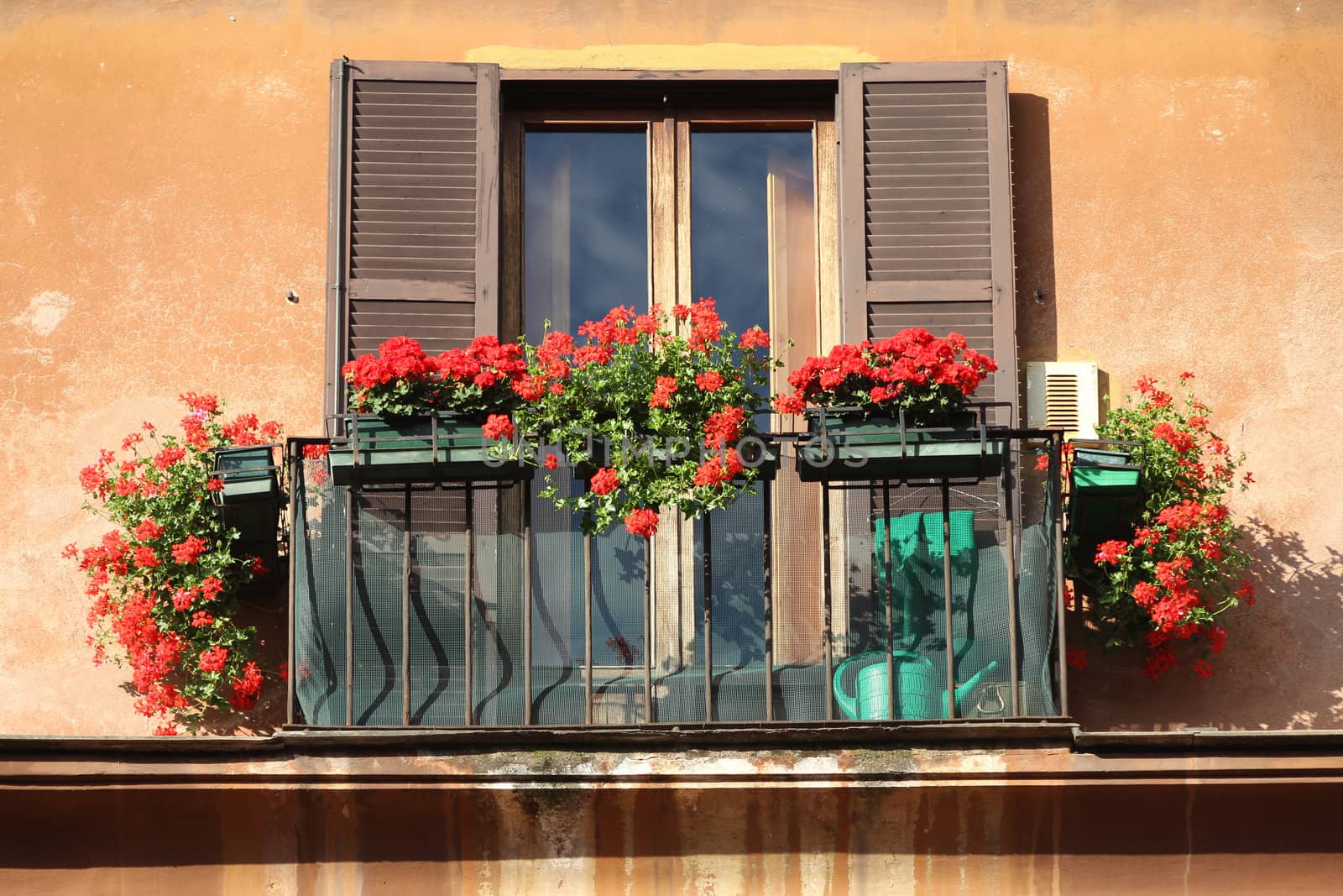 Rome, Italy. Beautiful window decorated with red flowers.