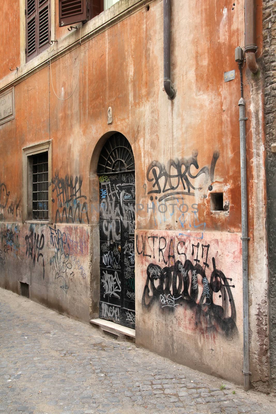 Rome, Italy. Street view of graffiti vandalism.
