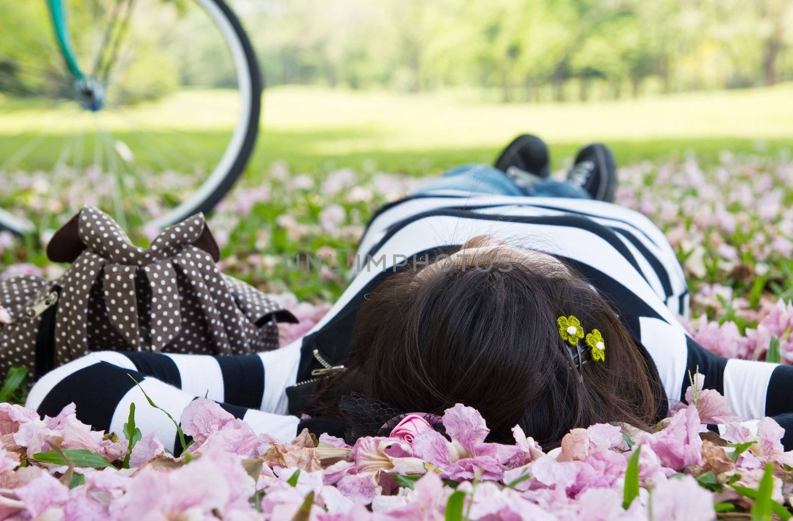 Asian woman sleeping on the grass by Myimagine