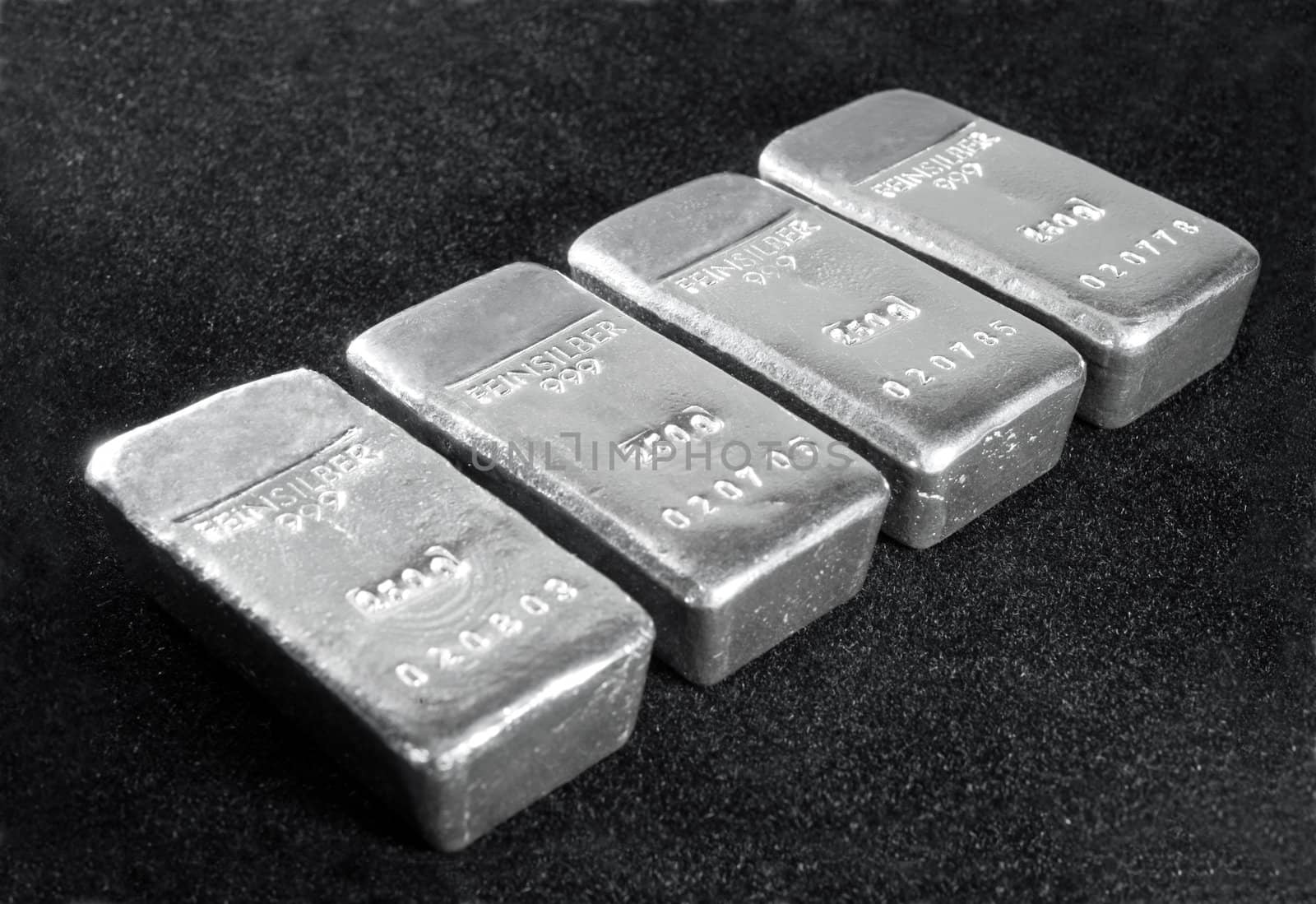 Processing and global trading of precious metals. Silver bars on a black background. Closeup.