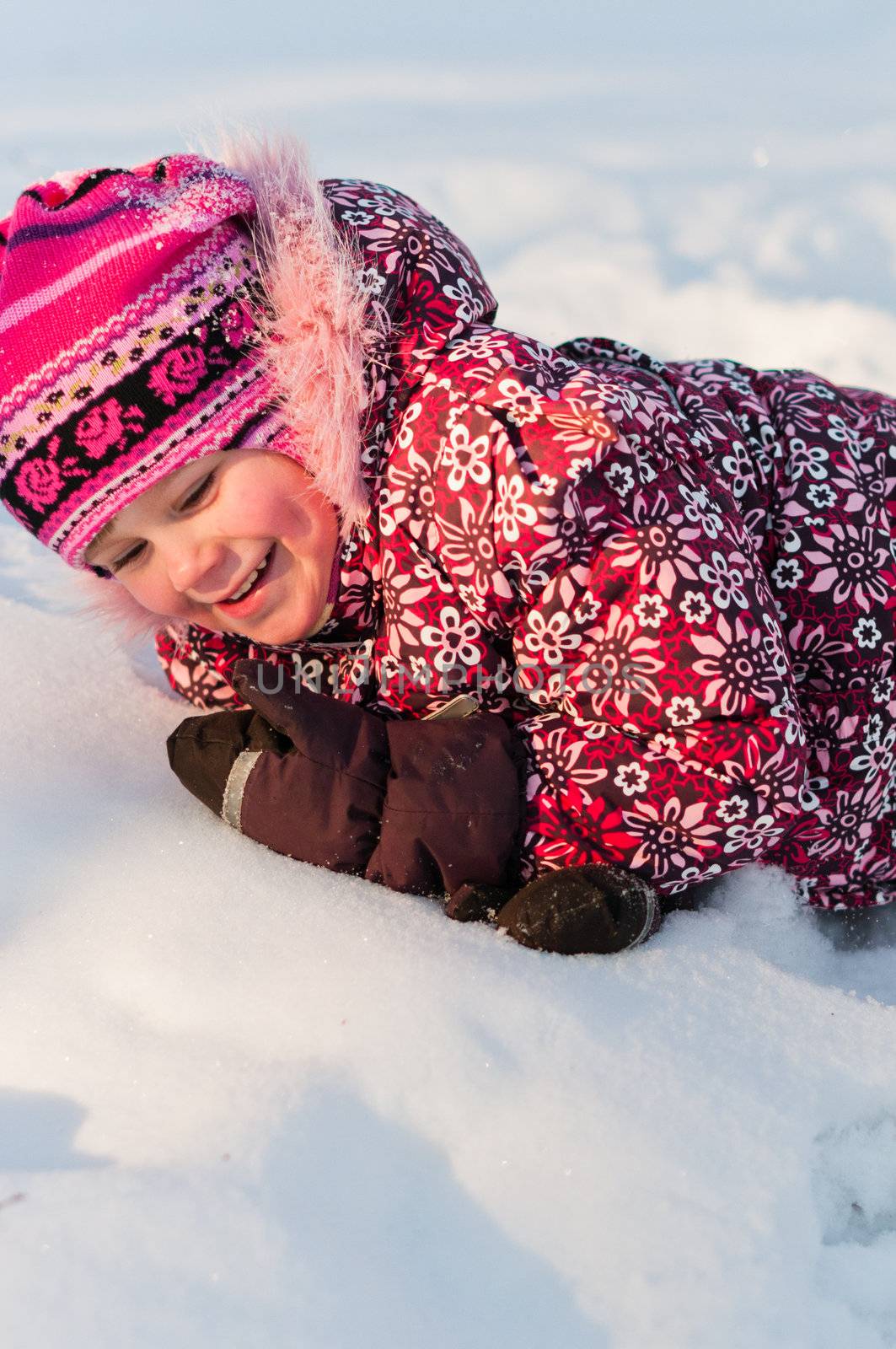 Baby lays on snow by dmitryelagin