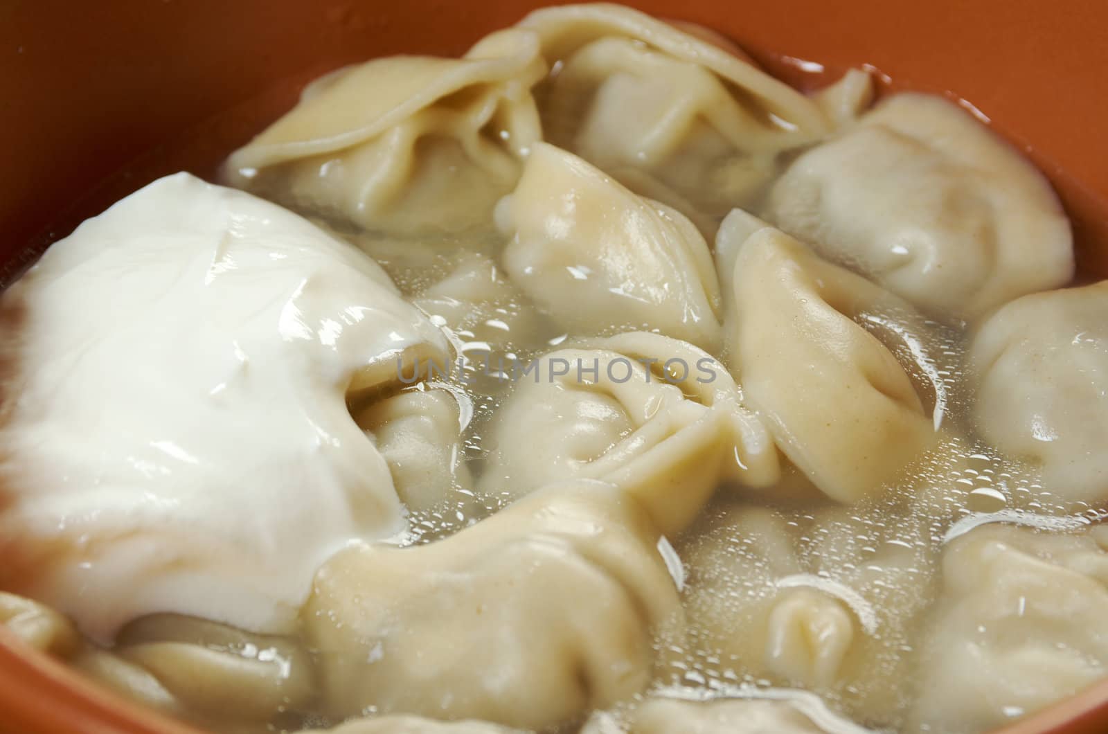 Traditional Russian food "pelmeni".Meat dumplings  with sour cream