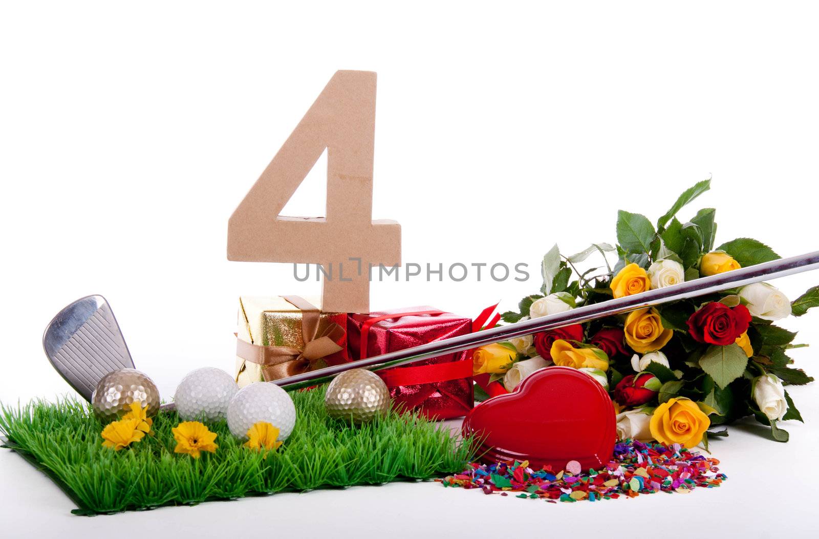 Roses, a golf club and golf balls on an artificial peace of grass to be used as a birthday card