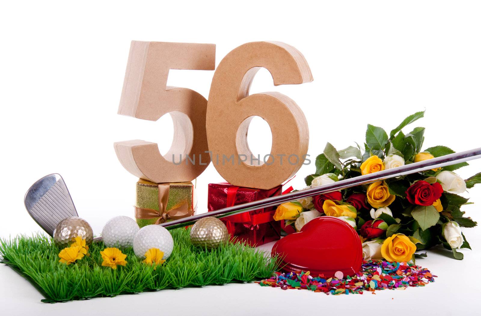 Roses, a golf club and golf balls on an artificial peace of grass to be used as a birthday card