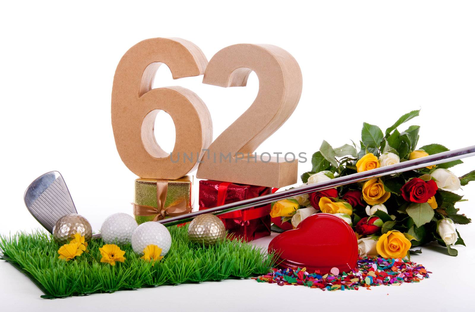 Roses, a golf club and golf balls on an artificial peace of grass to be used as a birthday card