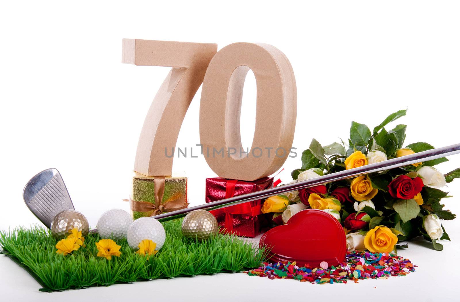 Roses, a golf club and golf balls on an artificial peace of grass to be used as a birthday card
