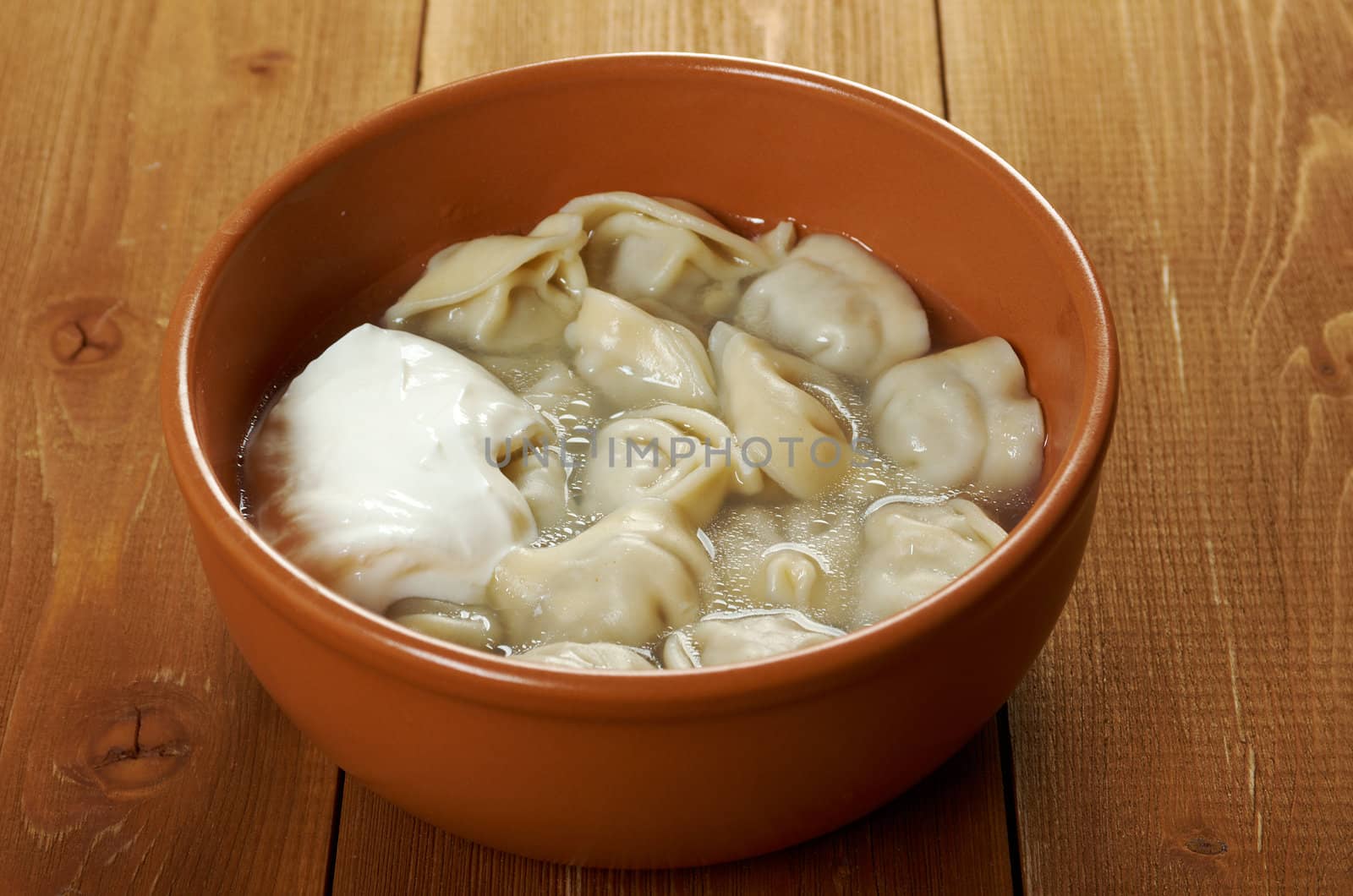 Traditional Russian food "pelmeni".Meat dumplings  with sour cream