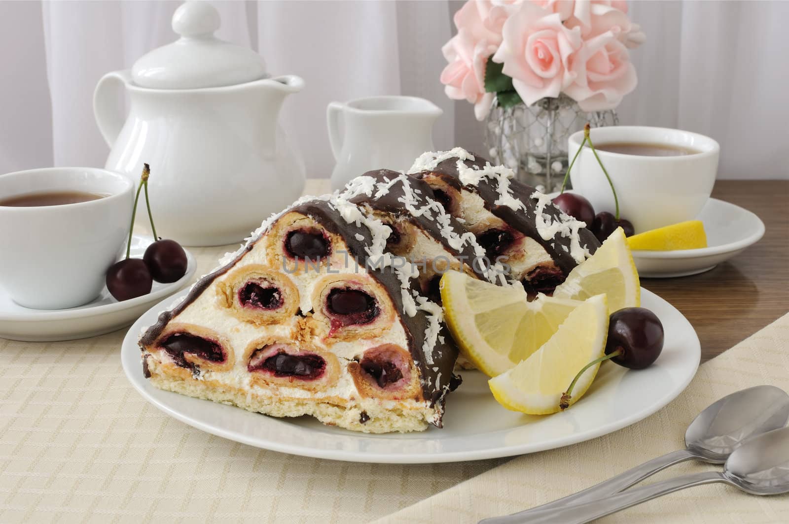 a piece of sponge cake dessert with  cream with cherries in chocolate icing and coconut