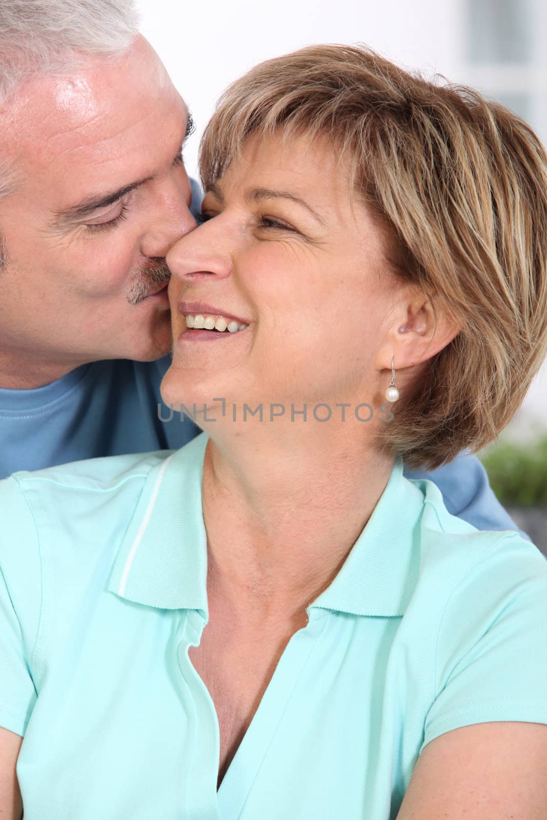 Mature couple kissing tenderly by phovoir