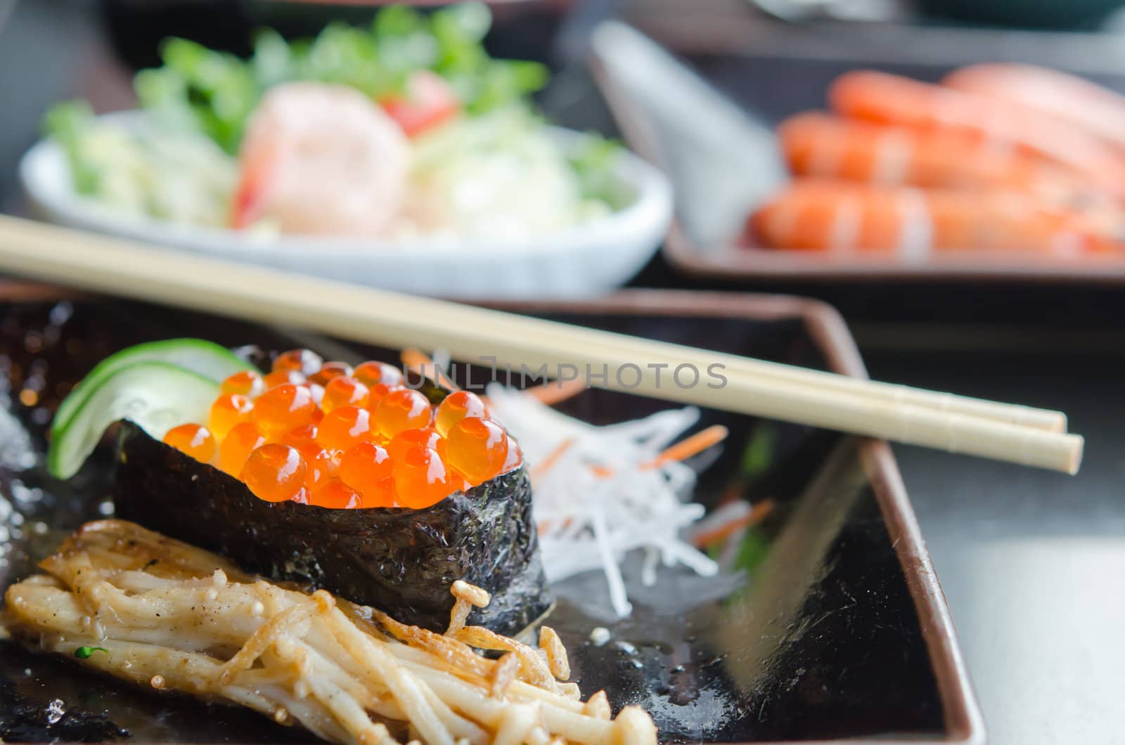 Salmon roe sushi  with vegetable on dish