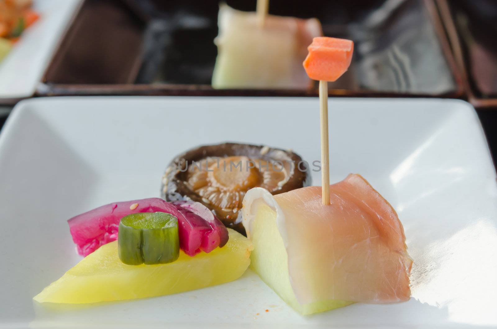 Salmon and fruit sticks with  melon and mixed pickled vegetable , asian style cuisine