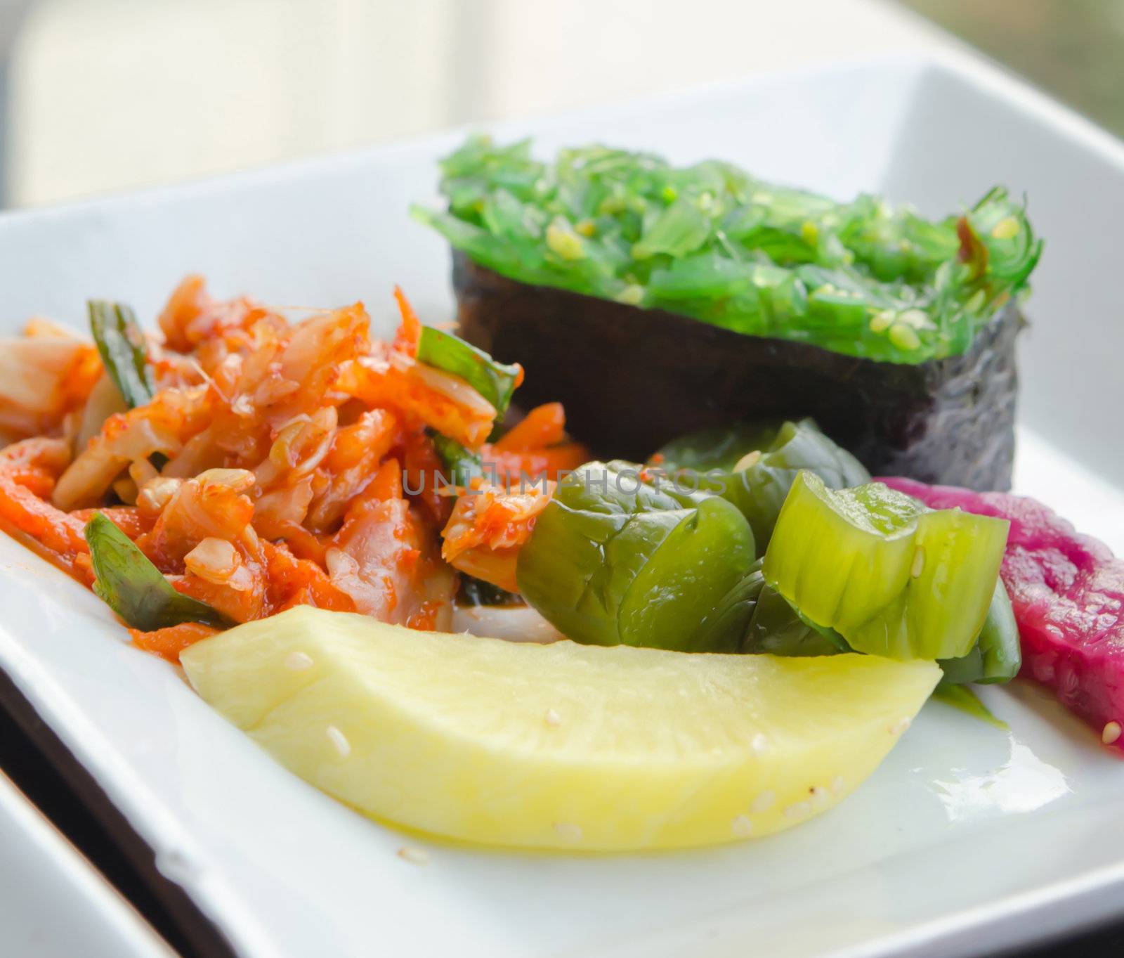 kimchi and pickled vegetable  , Chuka seaweed sush on white plate