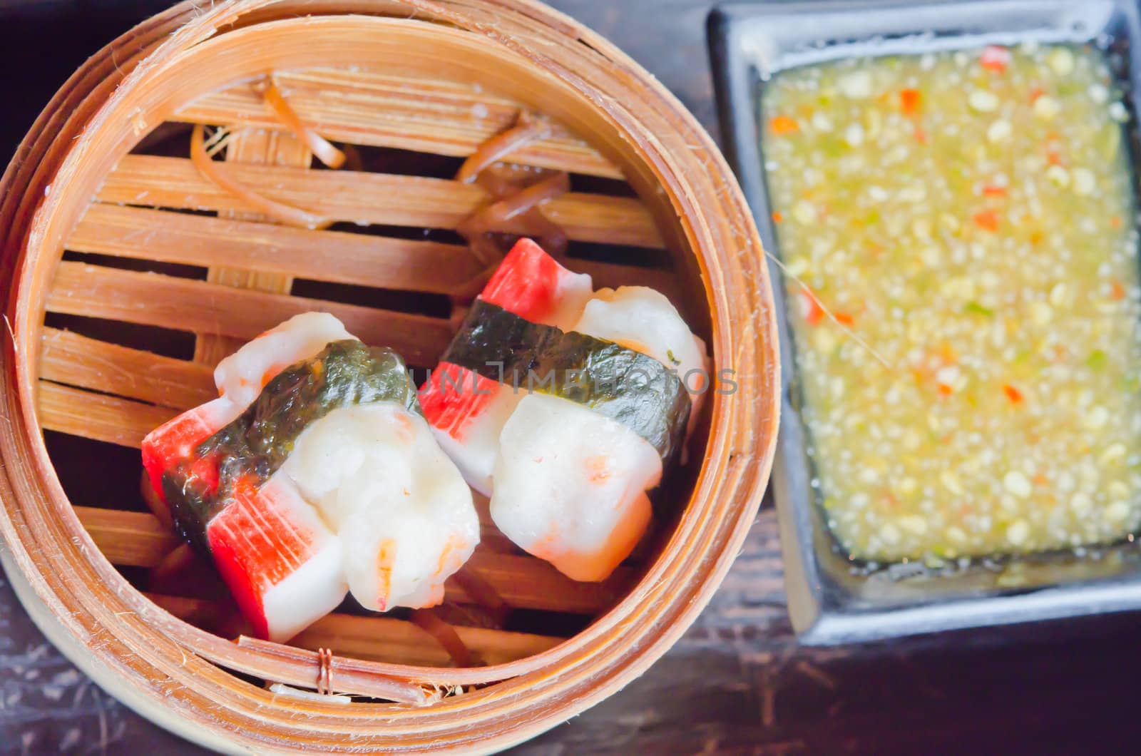 Chinese steamed dim sum crab in bamboo containers traditional cuisine , served with spicy sauce