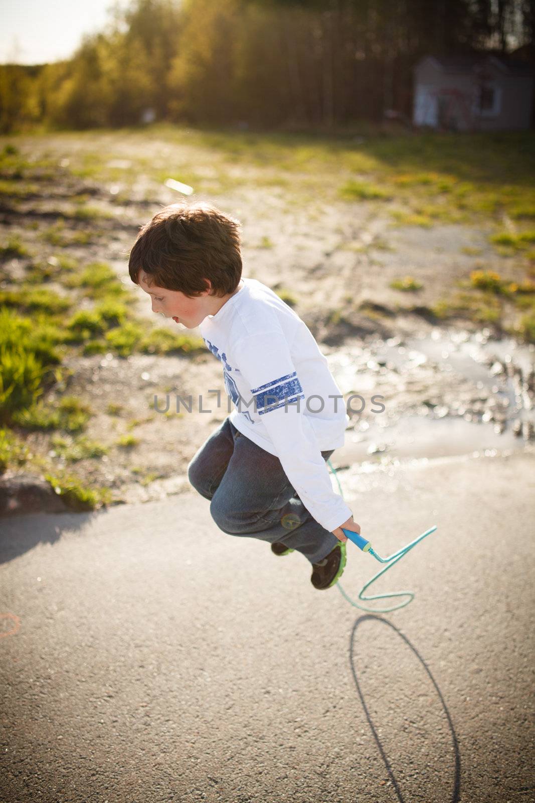 Cute little boy playing jump rope