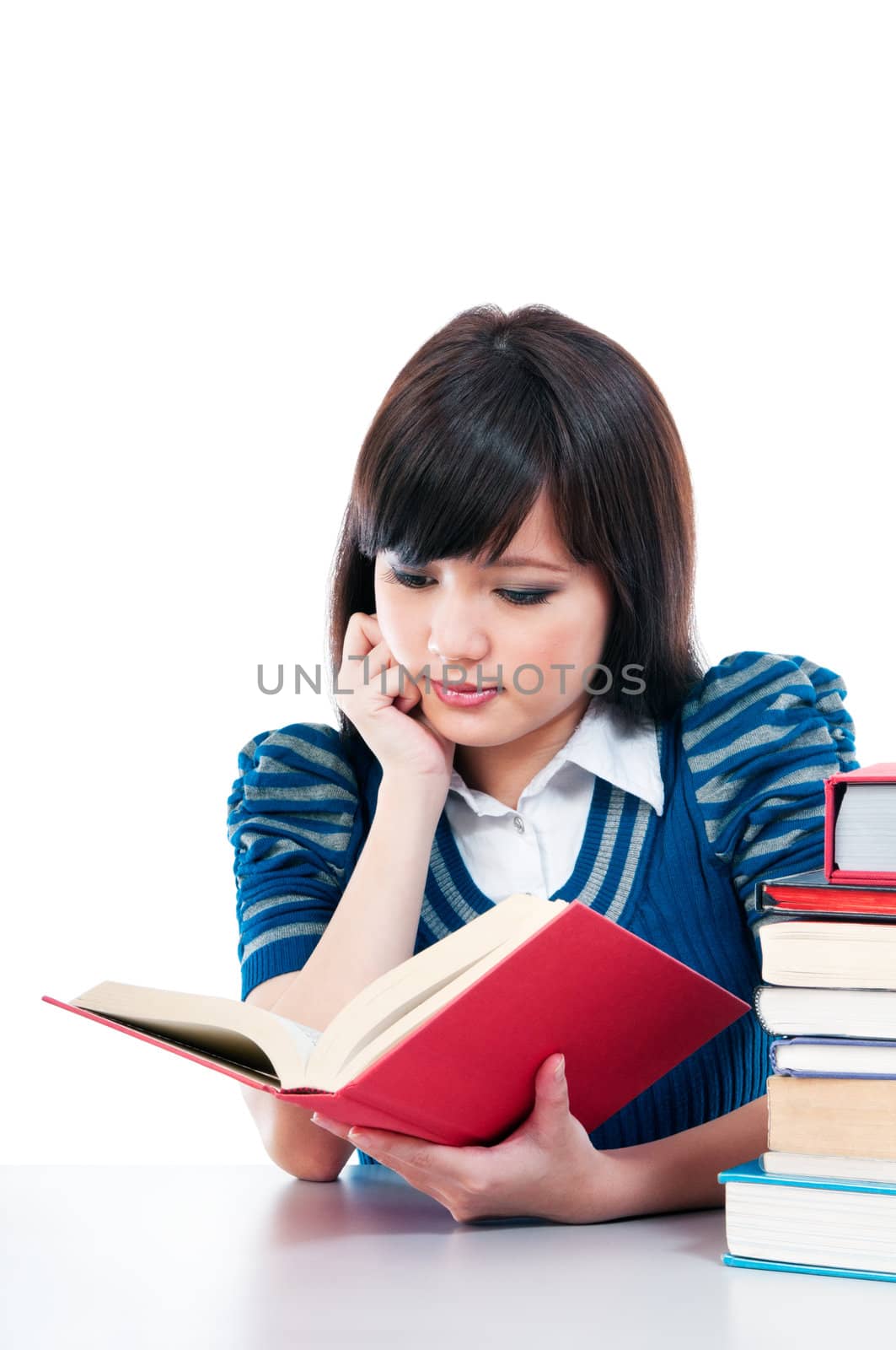 Portrait of a cute female student studying over white background.