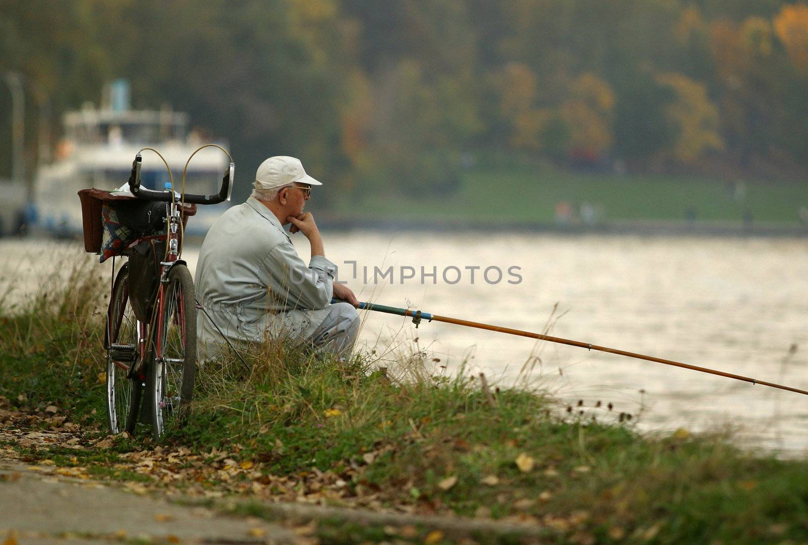 The person with a fishing tackle on a coast of the river