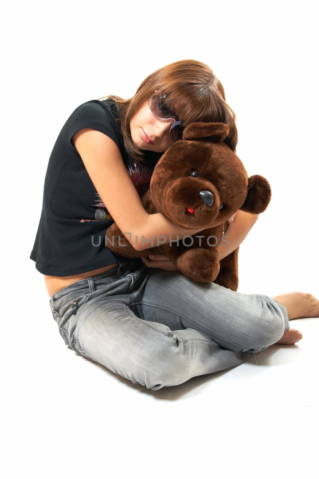 The girl with the teddy bear on a white background 