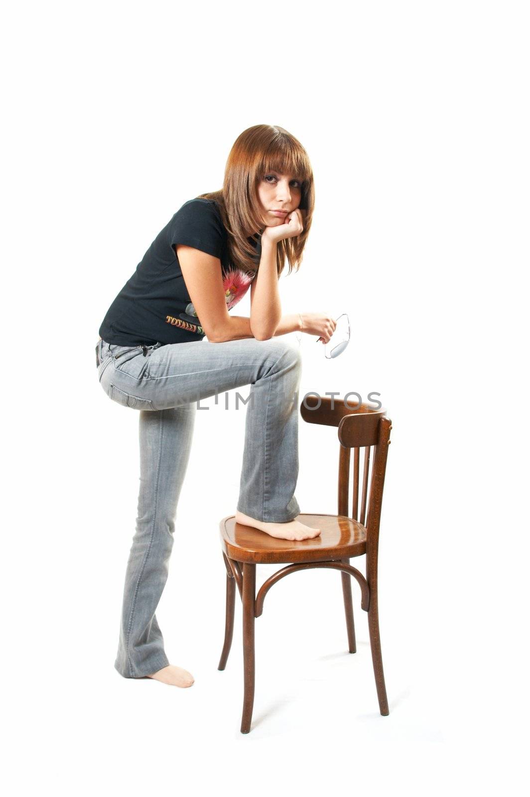 The girl with a chair on a white background 