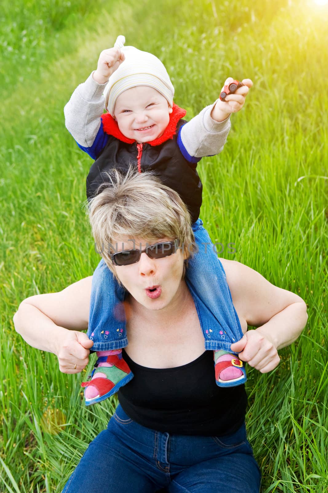 playing with grandmother in sunset by vsurkov